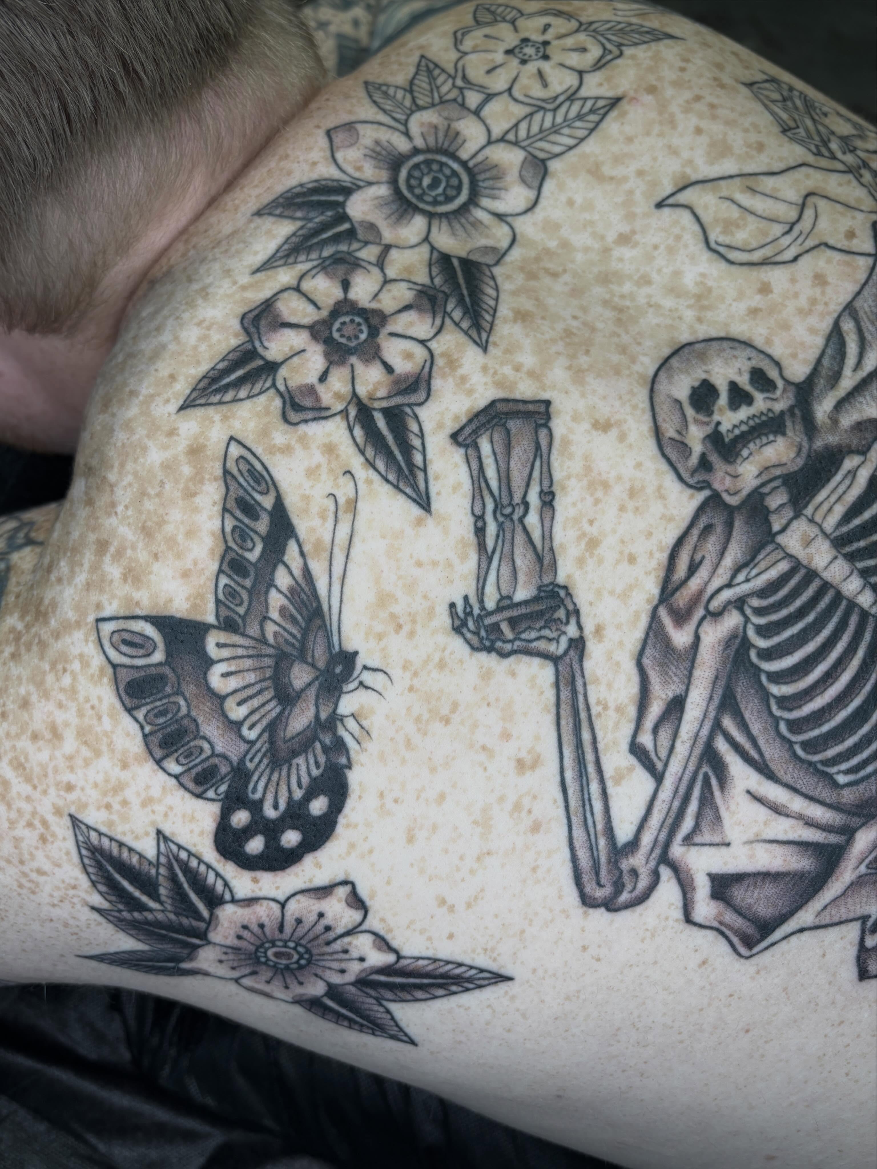 Butterfly and skeleton realism tattoo on the shoulder by Amelia Rose, Los Angeles, California