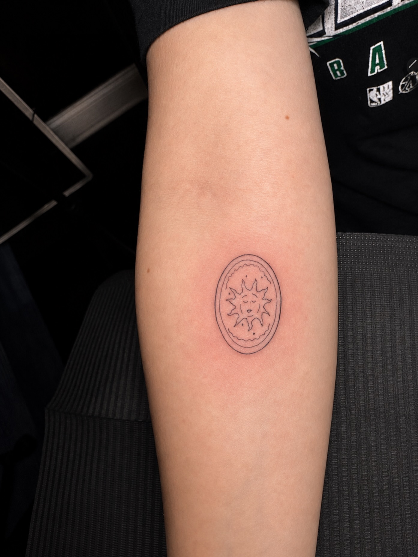 Sun minimalist tattoo on the forearm by Nicole
