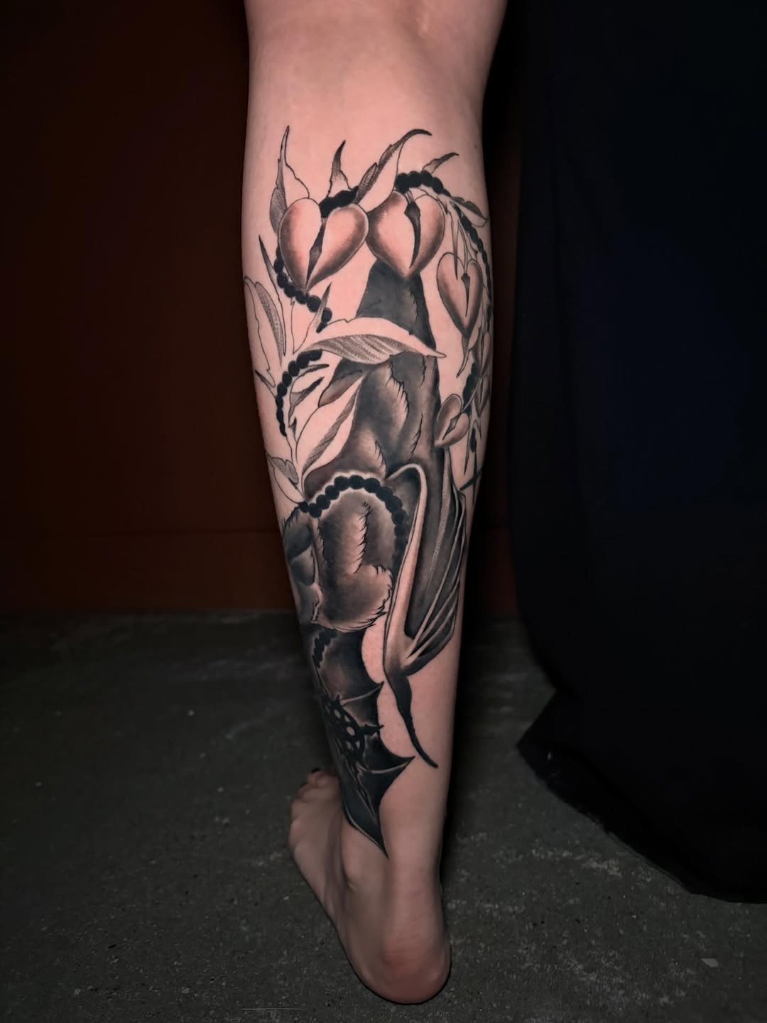 Bat and bleeding hearts realism tattoo on the calf by Kenzie Mecham-Cunningham