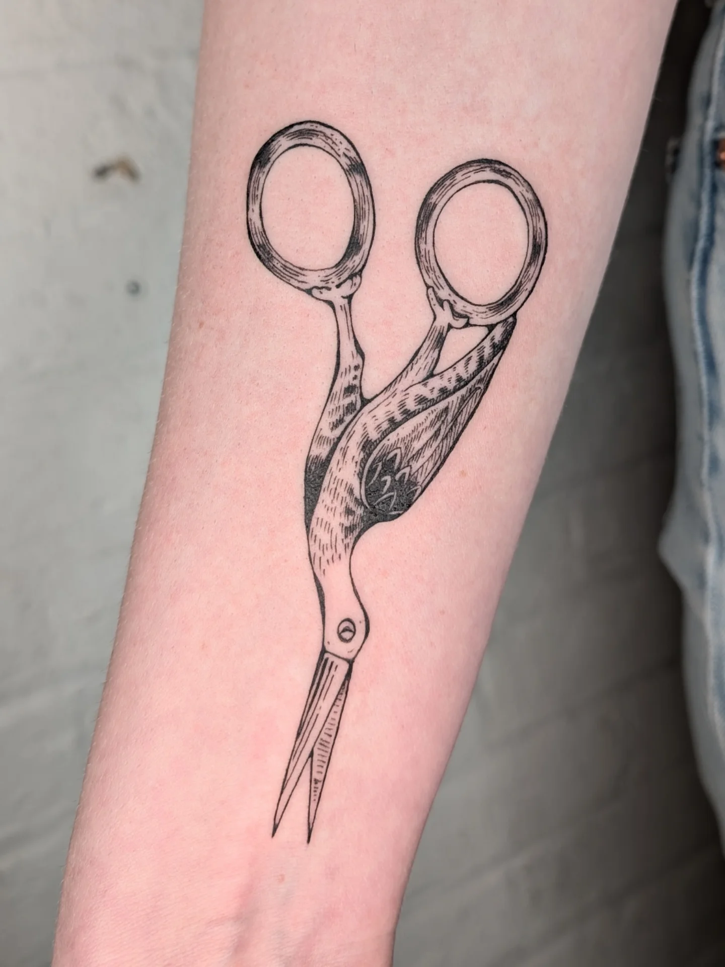Scissors black and grey tattoo on the forearm by mila