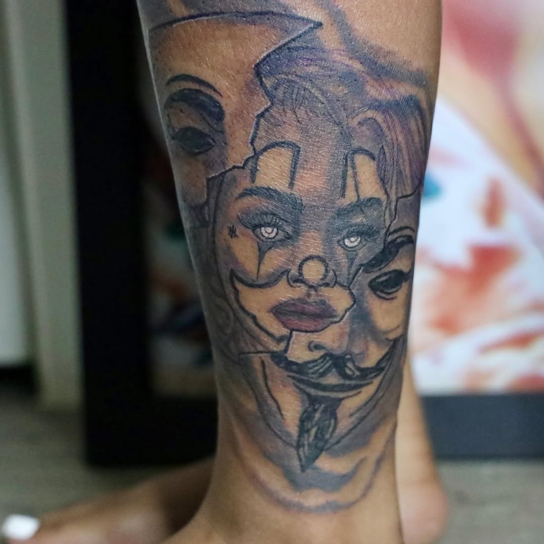 Mask black and grey tattoo on the forearm by D. Davis