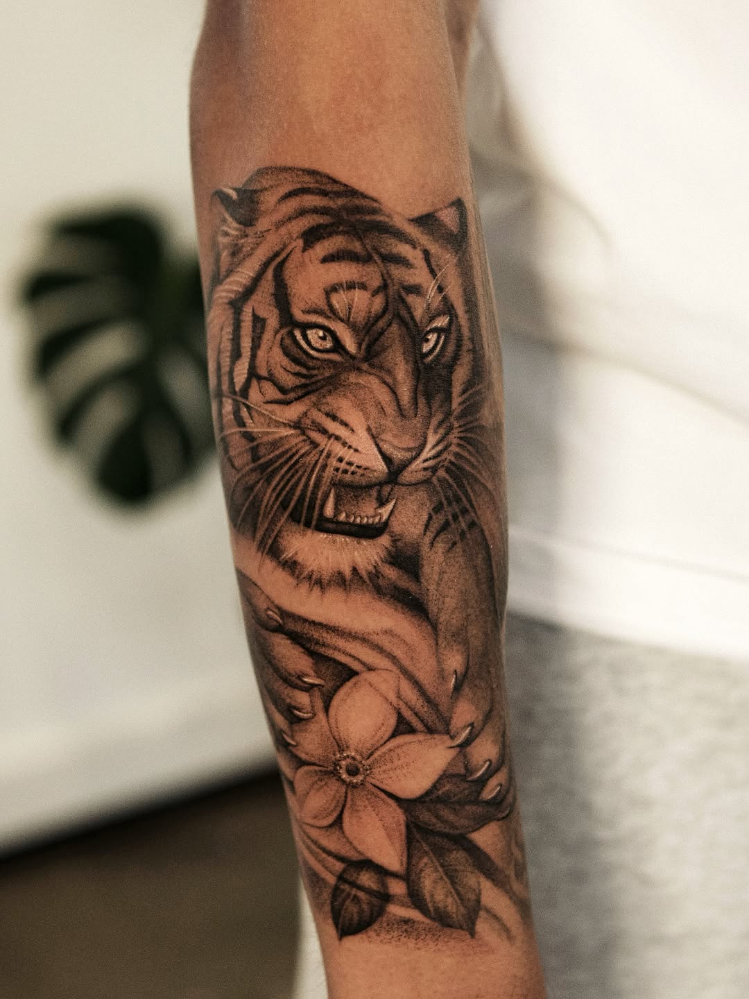 Tiger and flower realism tattoo on the forearm by Ray Quinday
