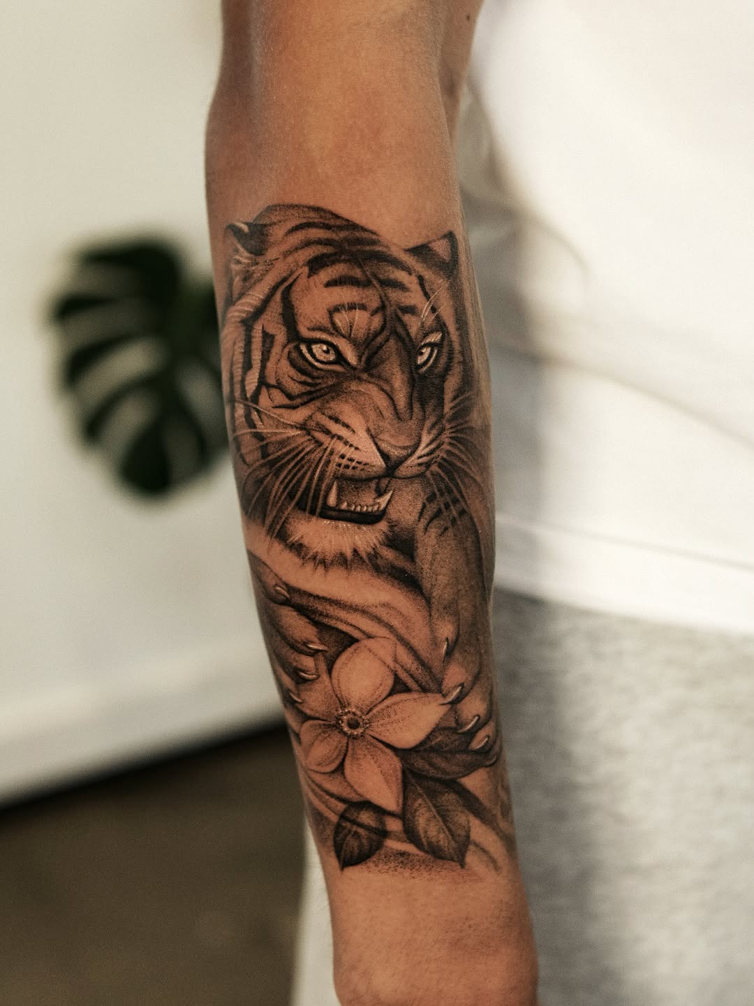 Tiger and flower realism tattoo on the forearm by Ray Quinday