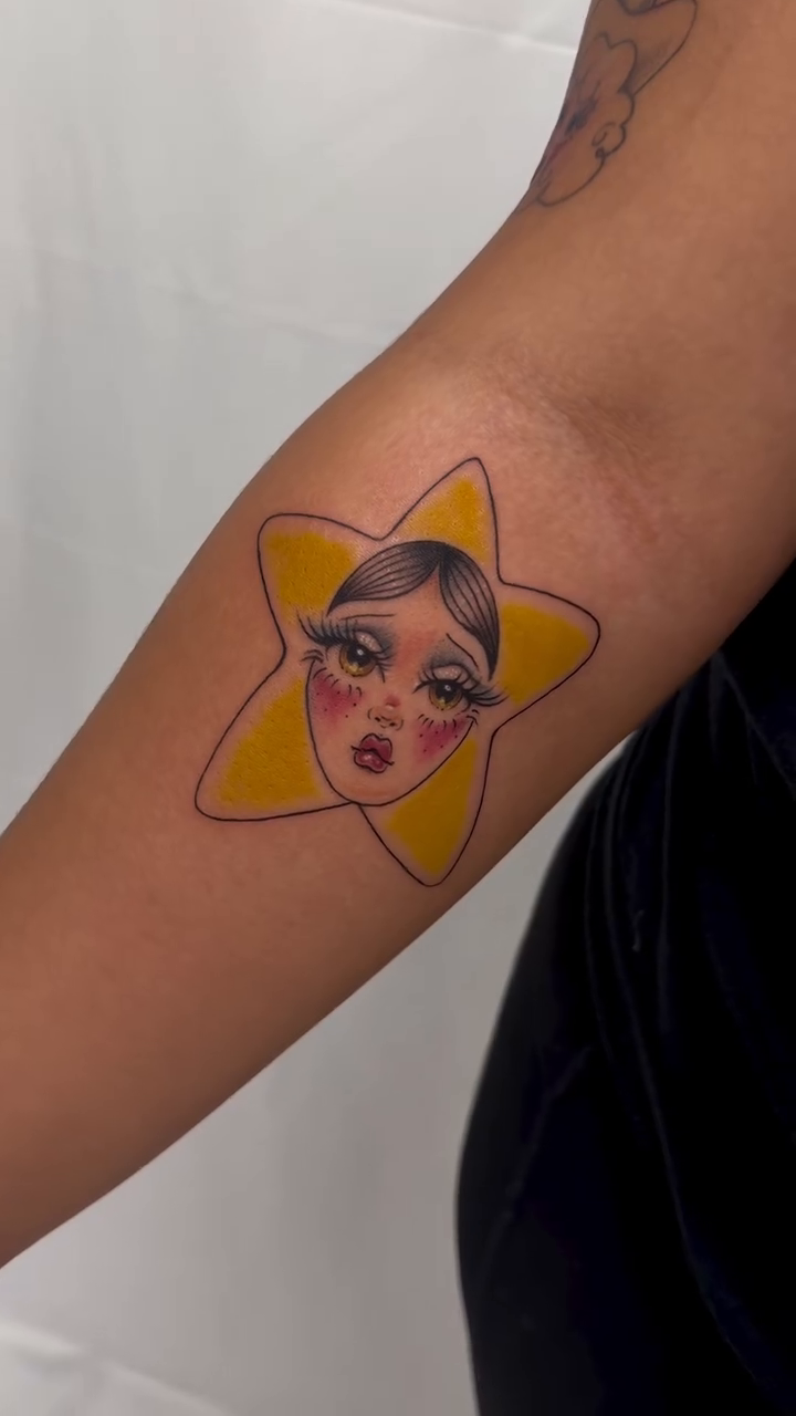 Star with a face surrealism tattoo on the forearm by tattooz by megz