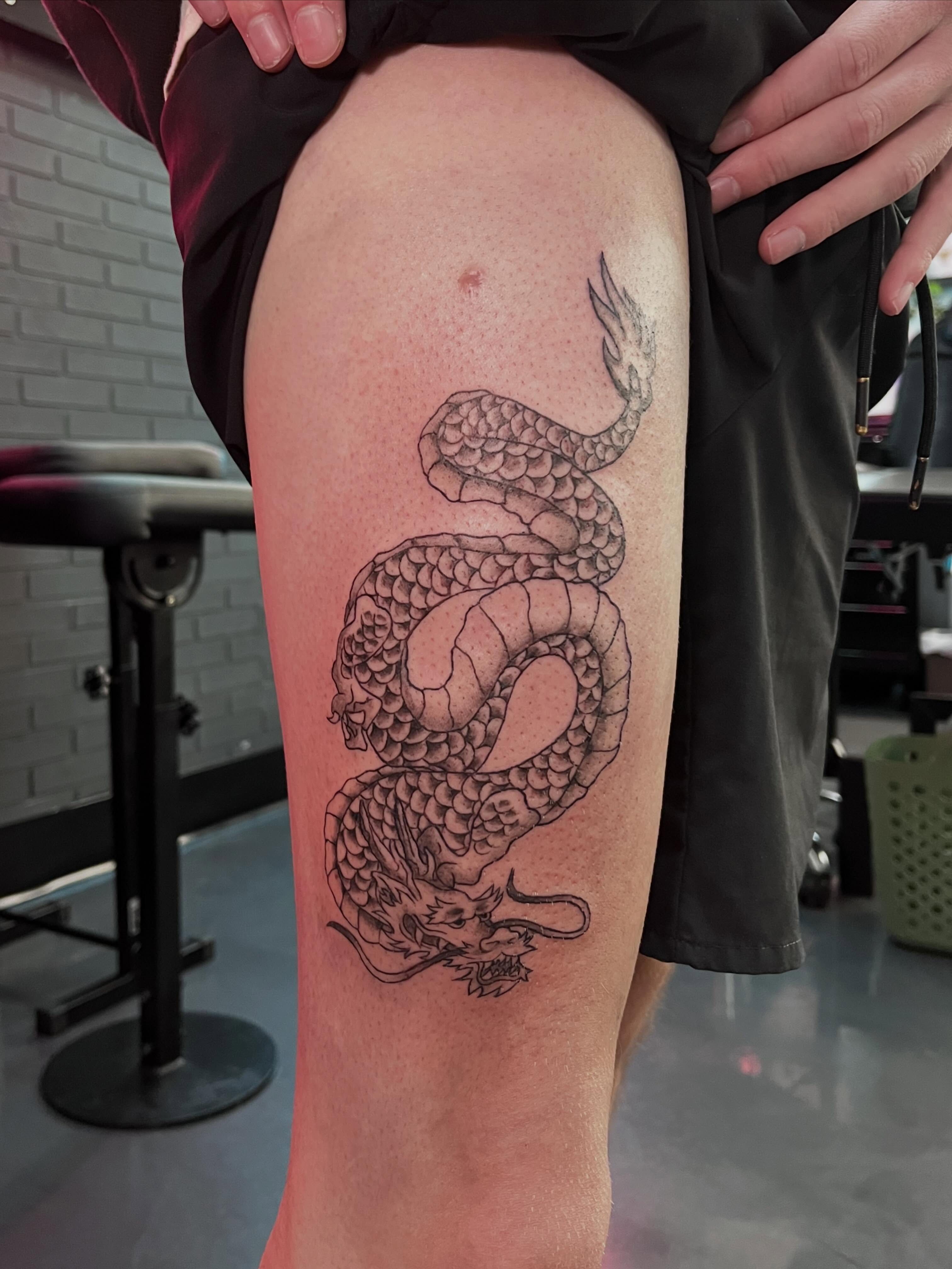 Dragon black and grey tattoo on the thigh by Bunny 🐰