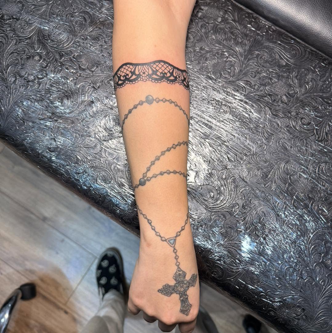 Lace and rosary black and grey tattoo on the forearm by Destiny A