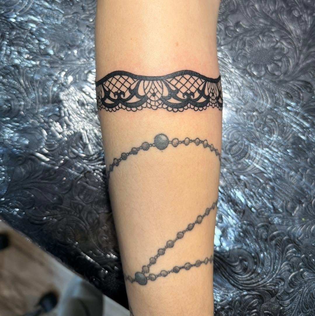 Lace and chain black and grey tattoo on the forearm by Destiny A