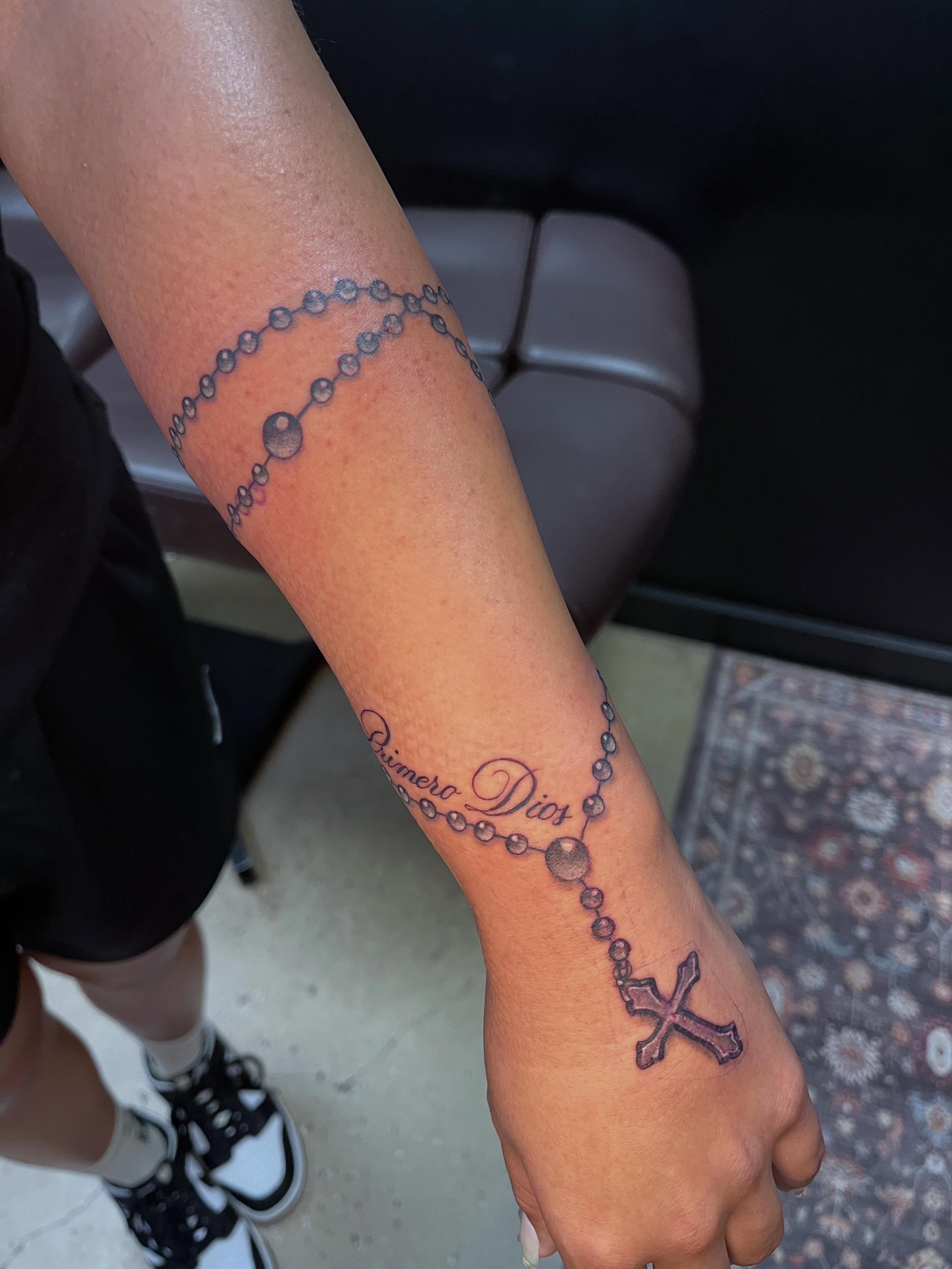 Rosary black and grey tattoo on the forearm by Tabitha Mathis
