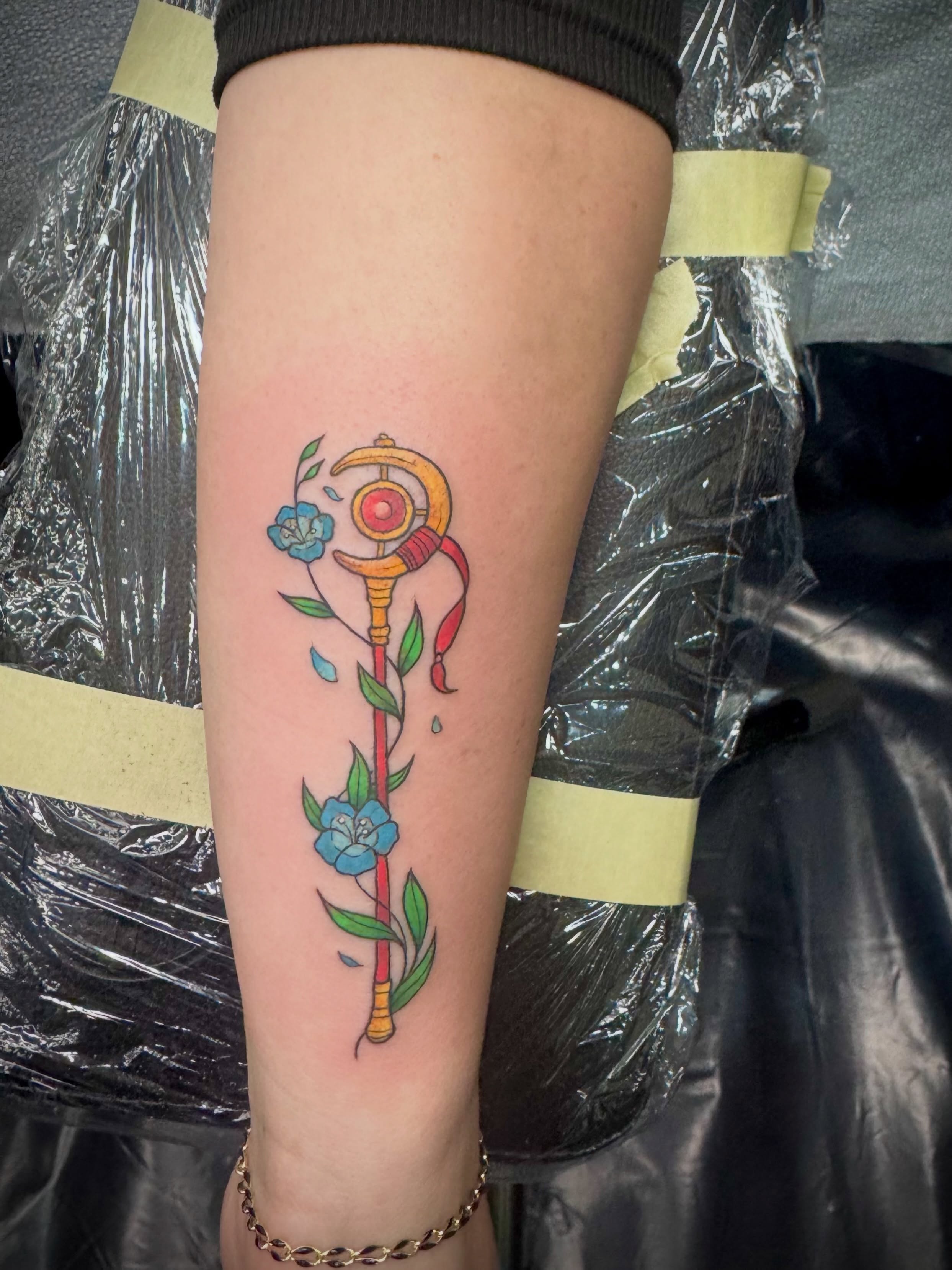 Sword and flowers new school tattoo on the forearm by Kylie Allen