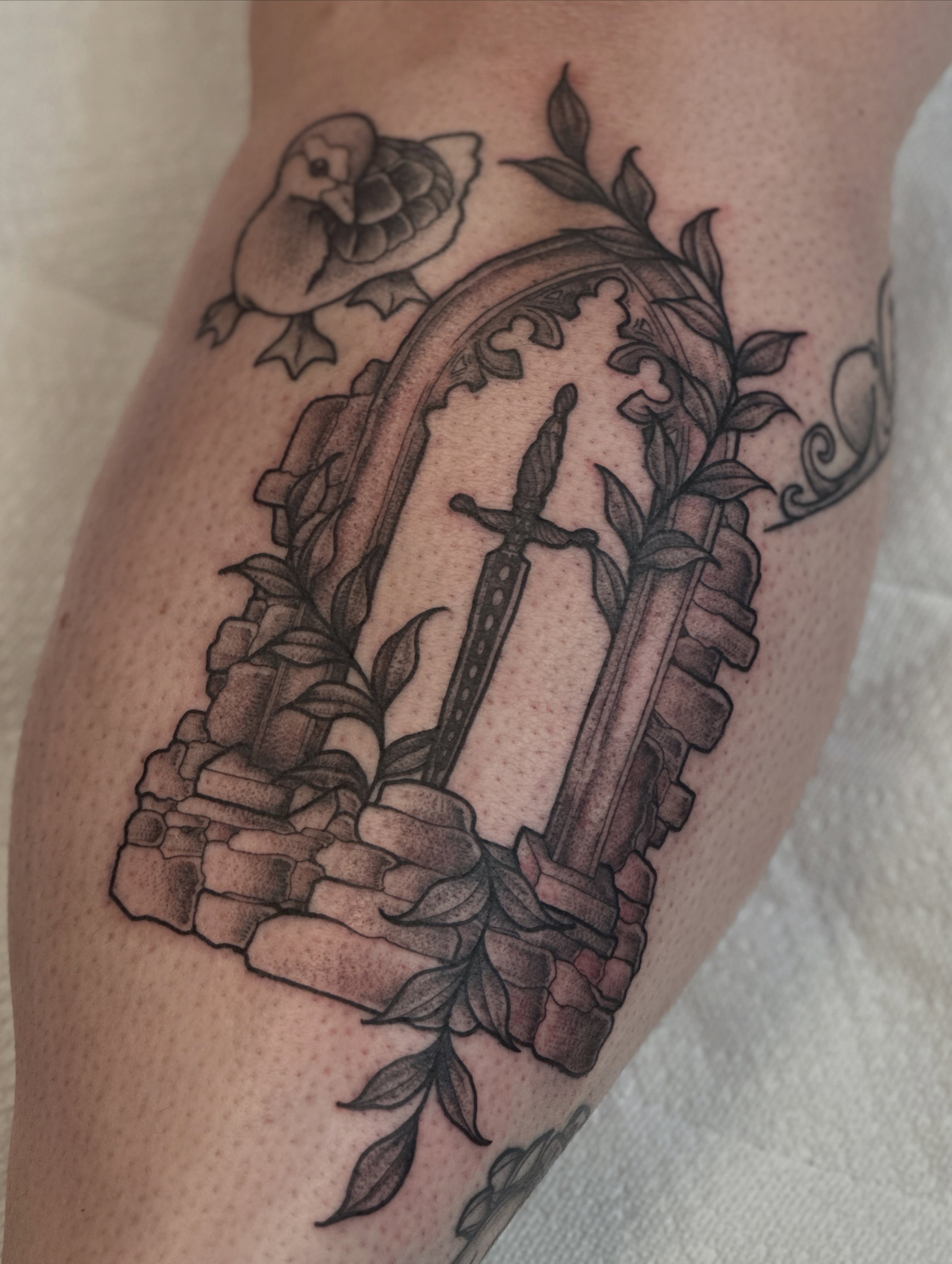 Sword and stone black and grey tattoo on the forearm by Gabrielle Brodman 🎀 Raleigh-Durham Tattoo