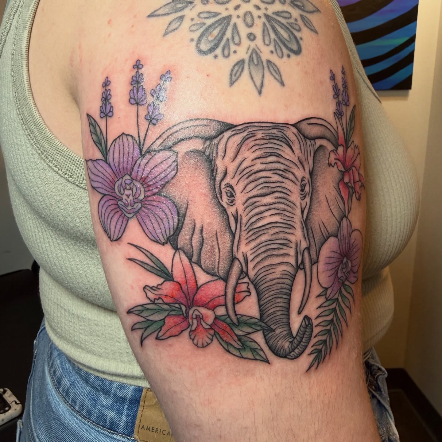 Elephant and flowers American traditional tattoo on the forearm by Jenna Nicole