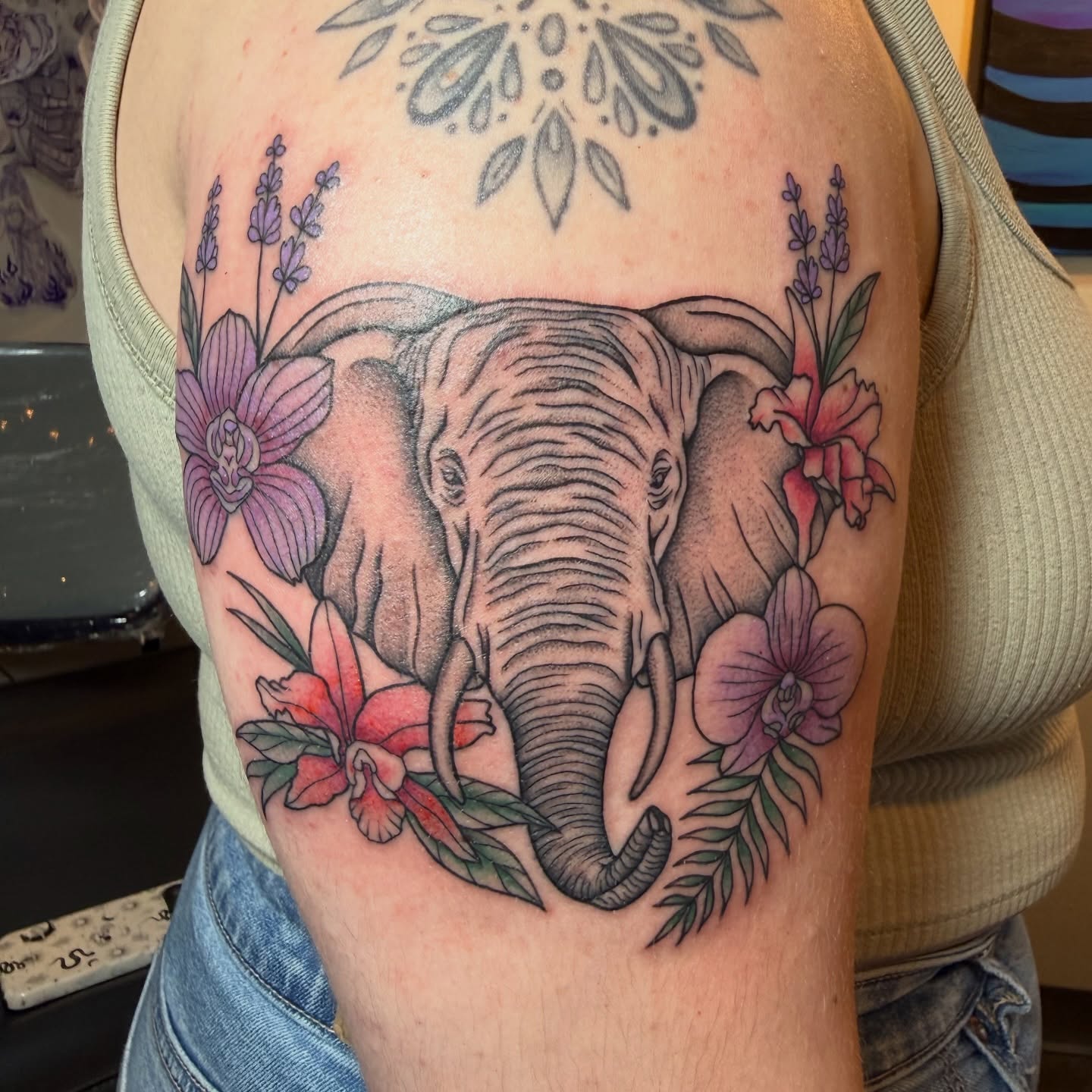 Elephant with flowers realism tattoo on the forearm by Jenna Nicole