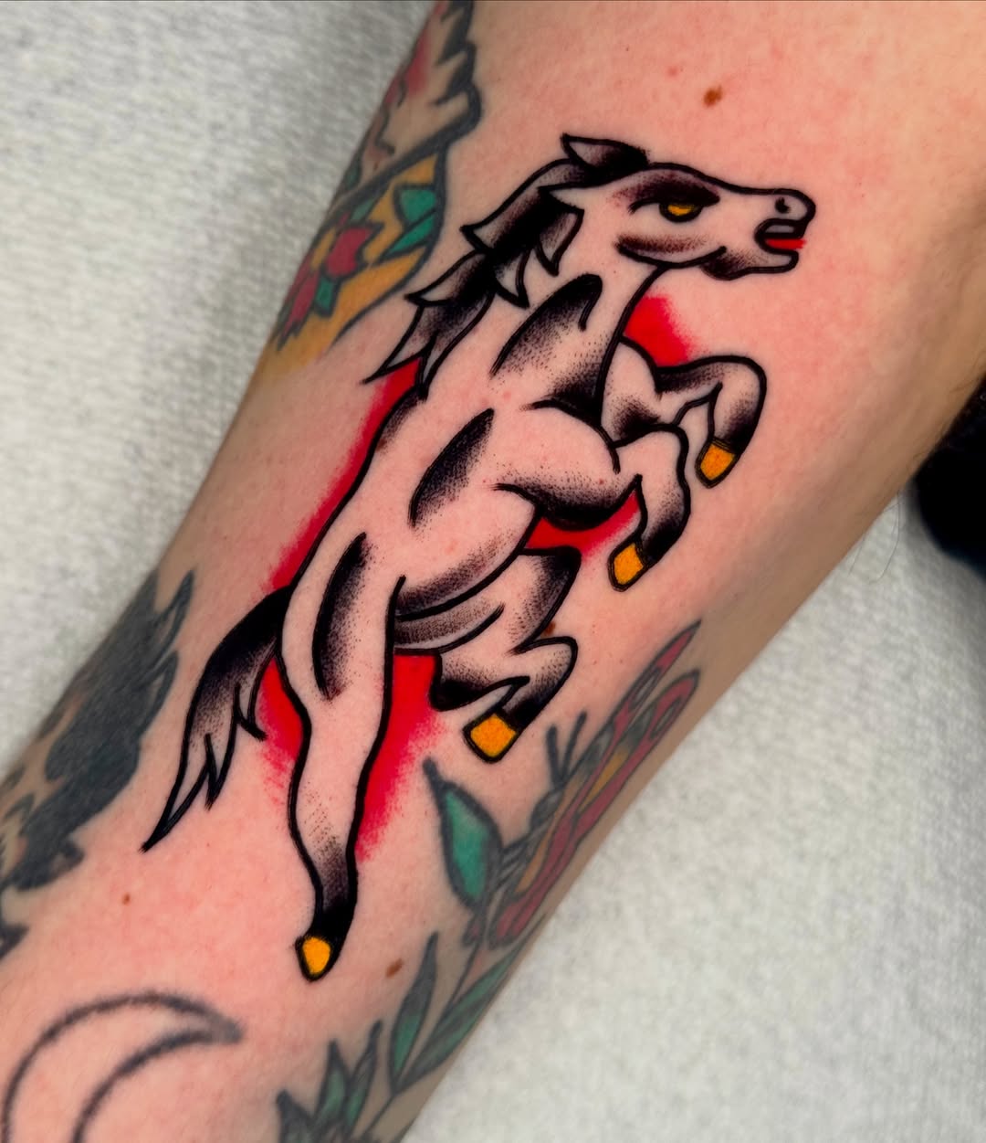 Galloping horse American traditional tattoo on the forearm by Joe Bear Tattooer