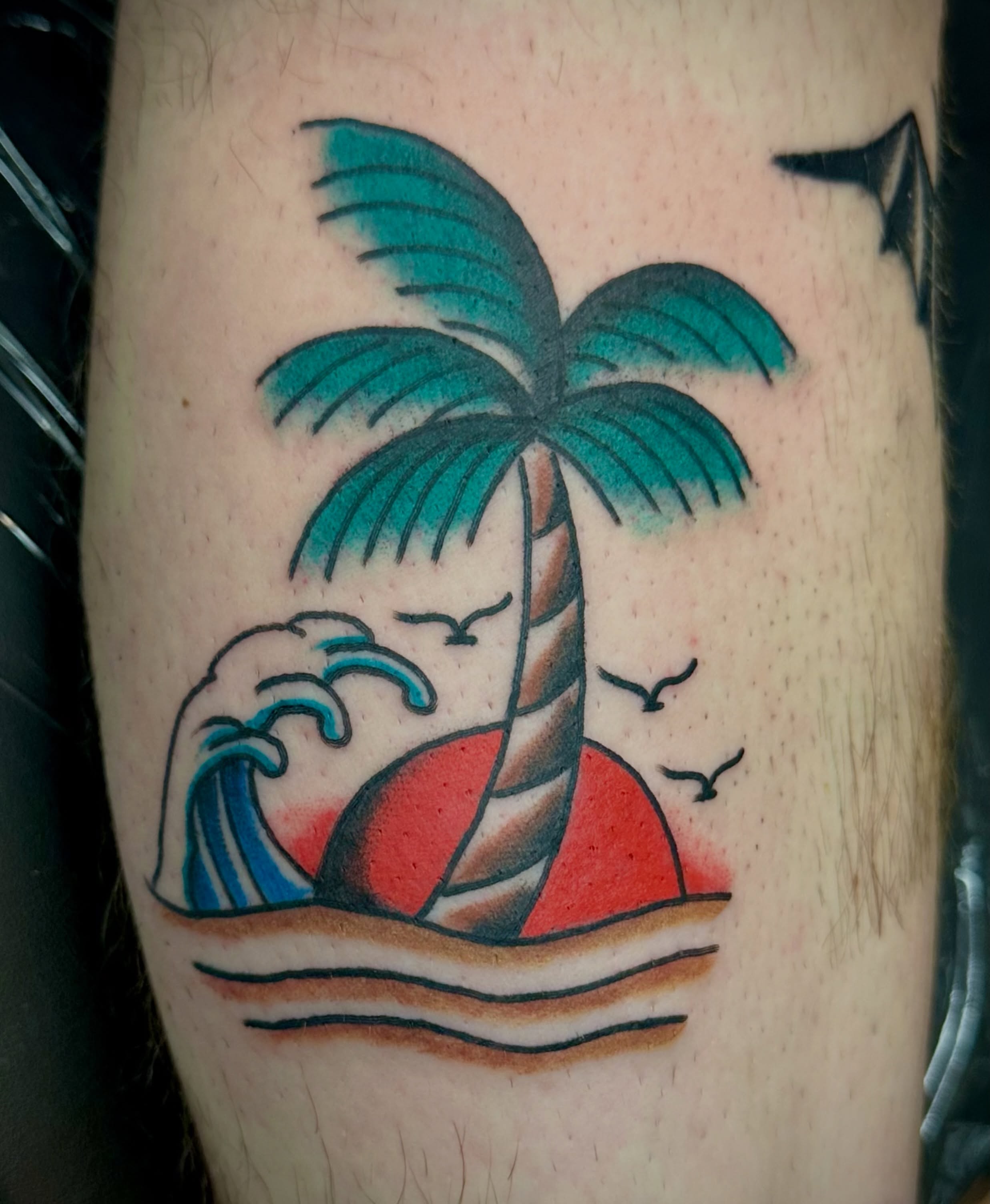 Sunset with palm tree American traditional tattoo on the forearm by Josh Robinson