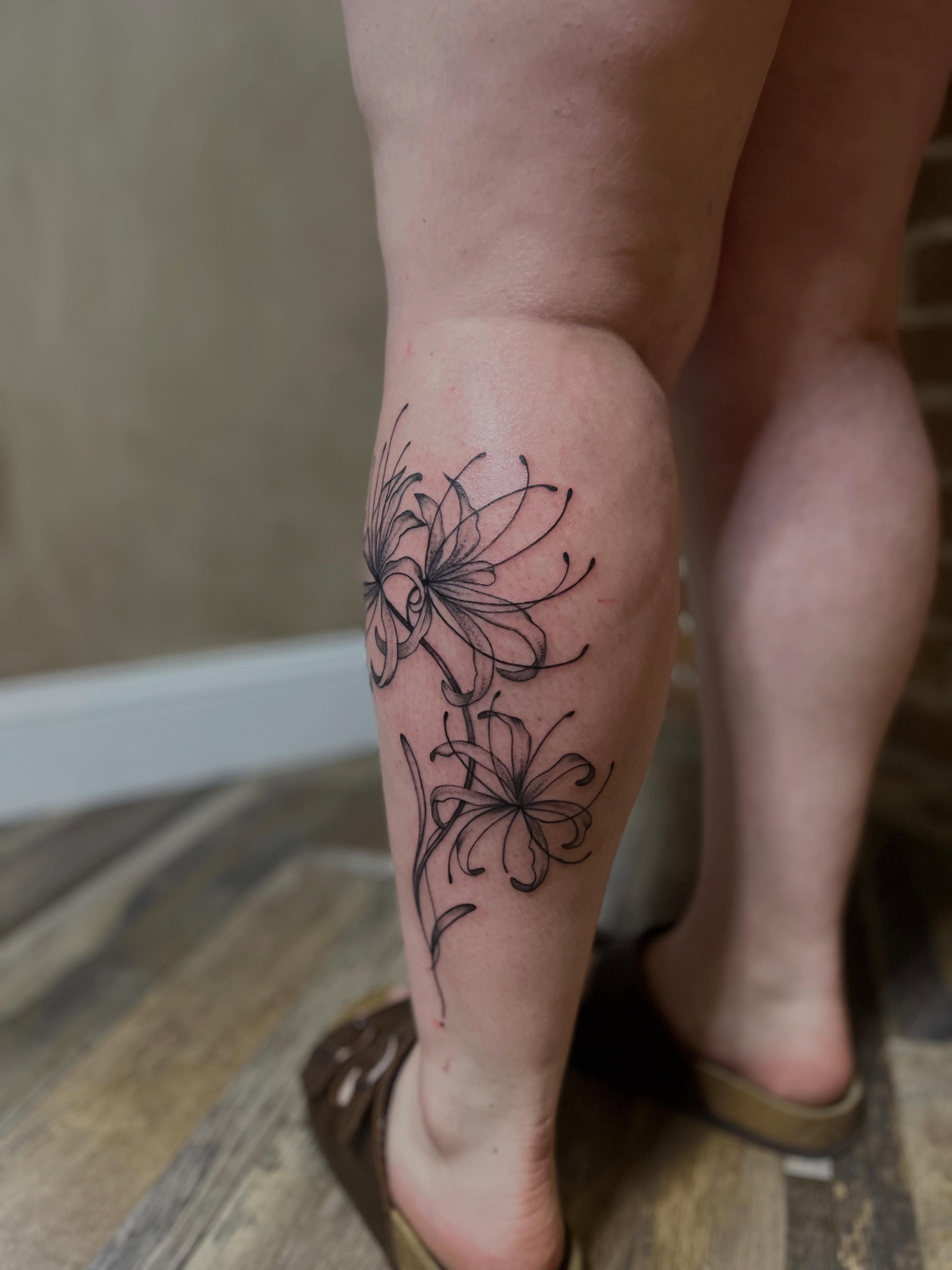 Lilies black and grey tattoo on the calf by Tattoo Artist, Kansas City, Missouri