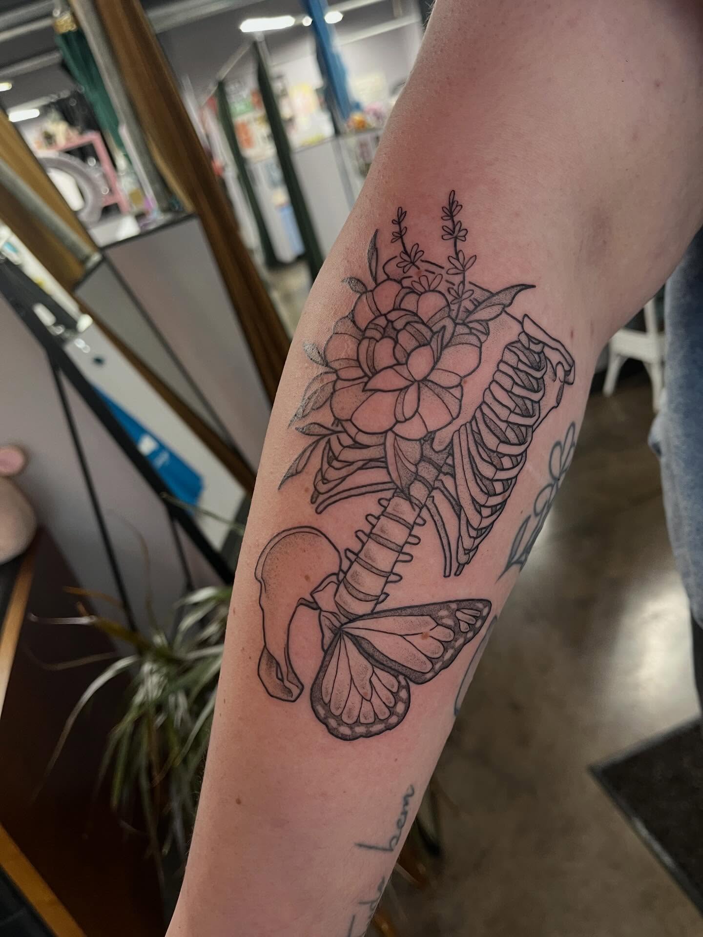 Butterfly and floral arrangement realism tattoo on the forearm by bunny, Minneapolis, Minnesota