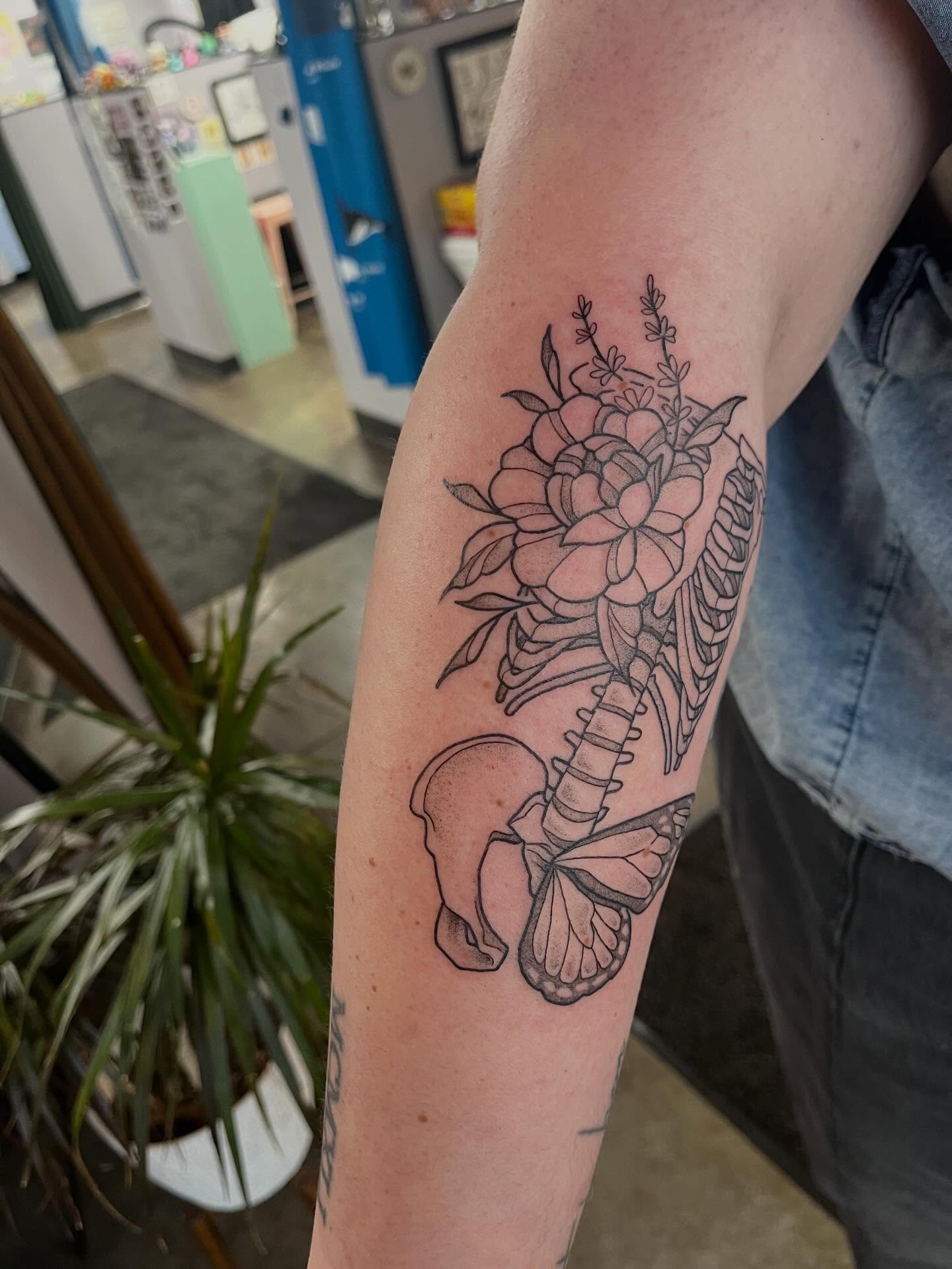 Flower and butterfly black and grey tattoo on the forearm by bunny, Minneapolis, Minnesota