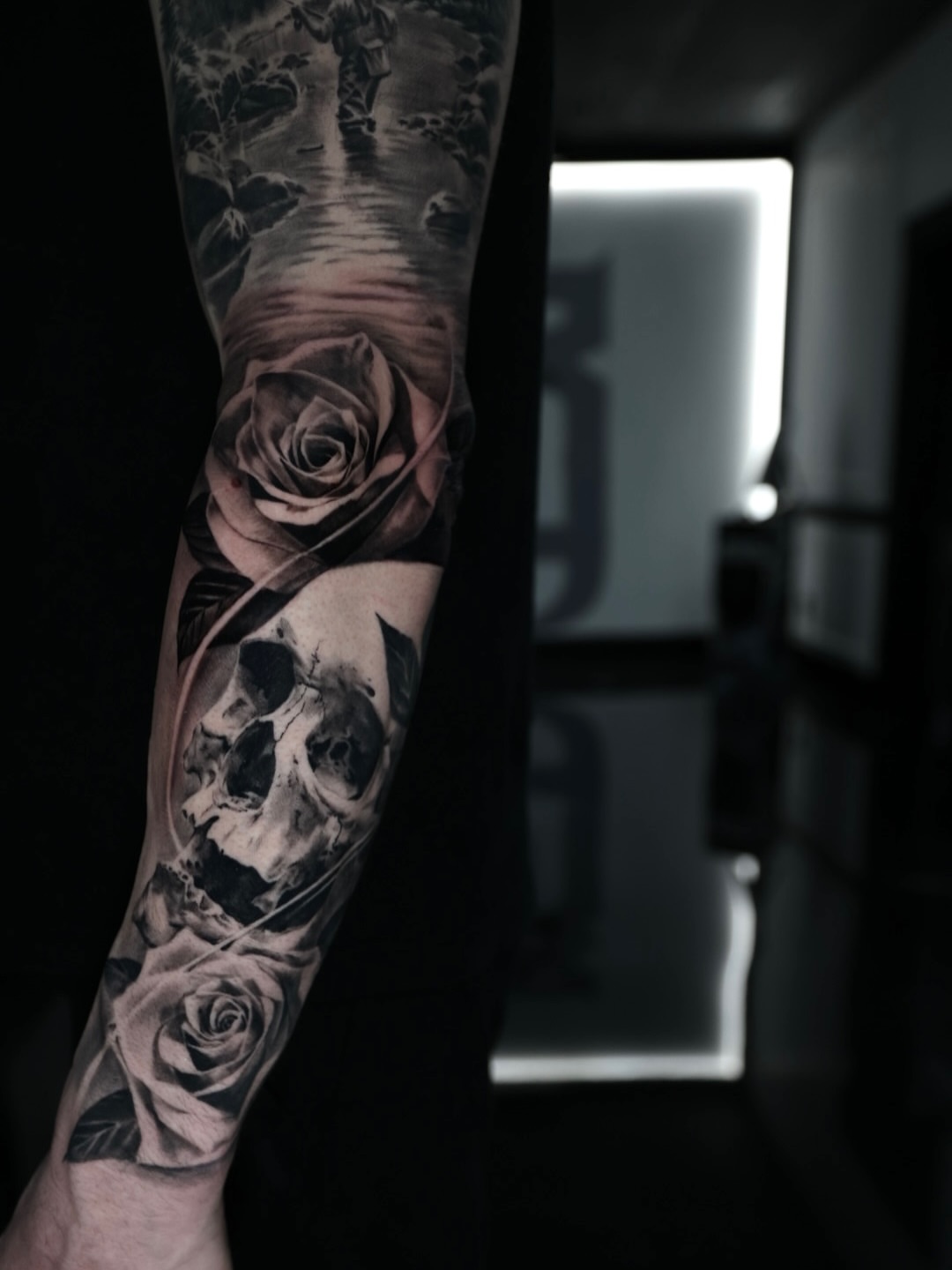Skull and roses realism tattoo on the forearm by Matthew Brown, Londonderry, New Hampshire