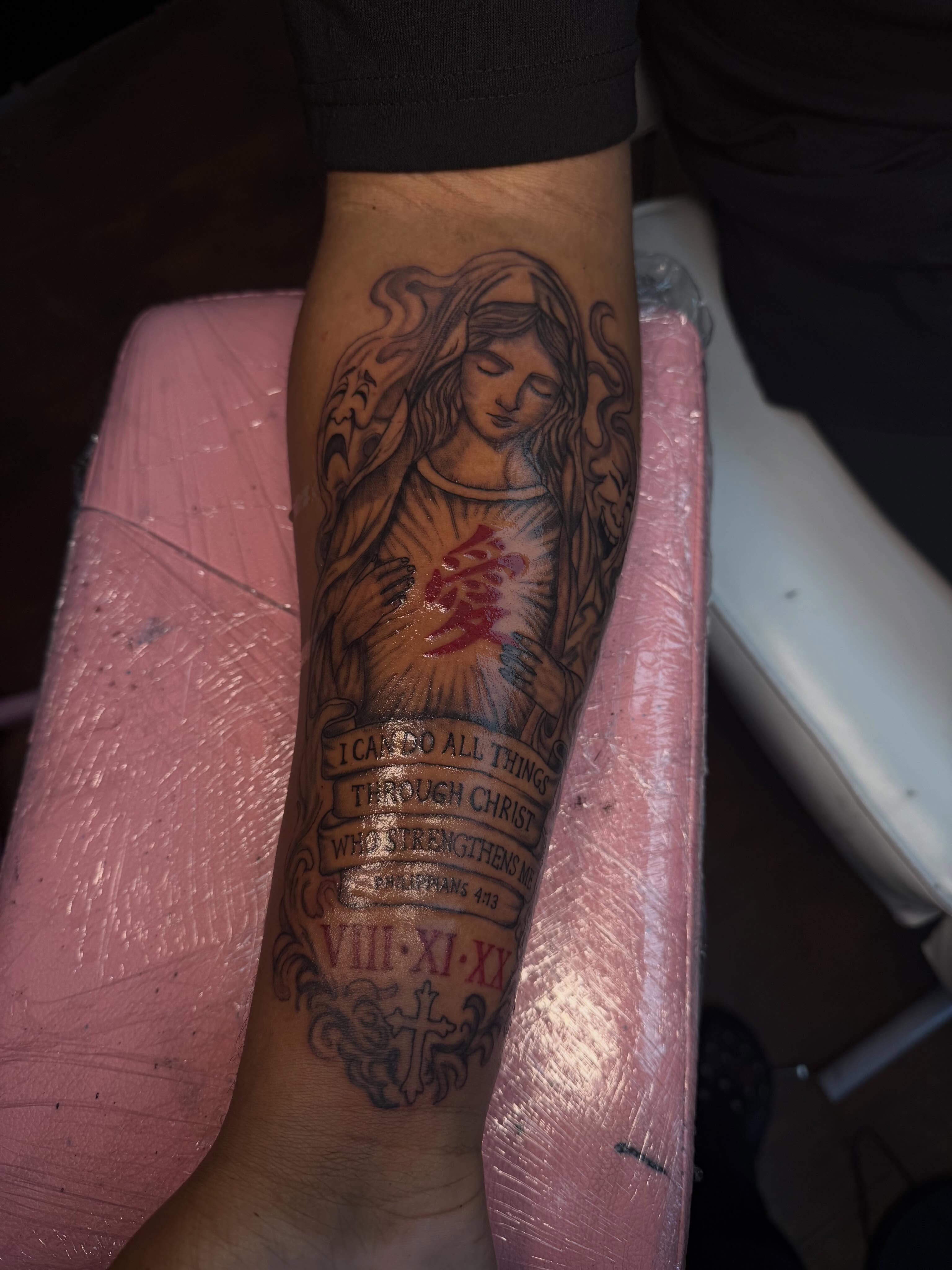 Religious figure with scripture black and grey tattoo on the forearm by addicted222inkk🎨