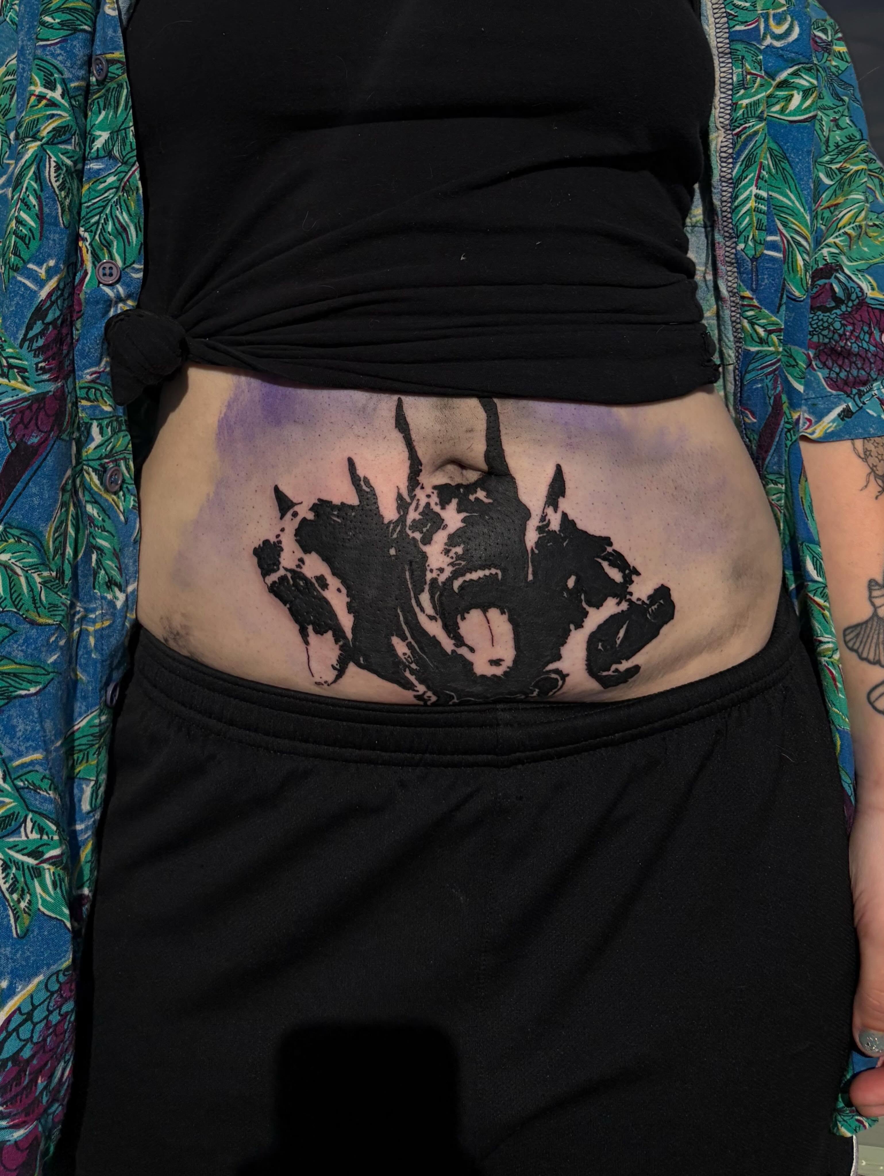 Abstract black and grey tattoo on the torso by neal