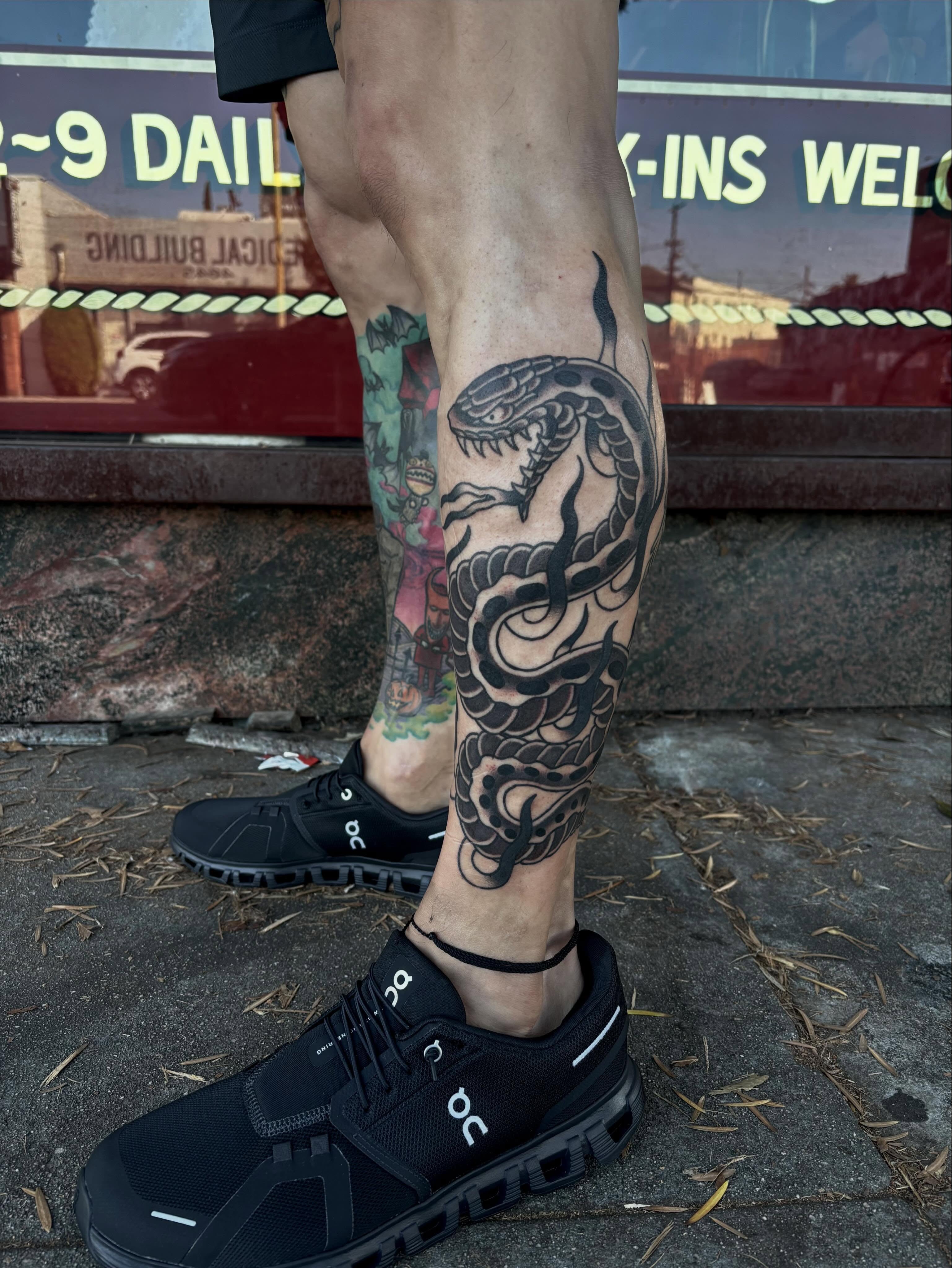 Snake black and grey tattoo on the calf by Alyssa L'Heureux🕴🏼, Los Angeles, California