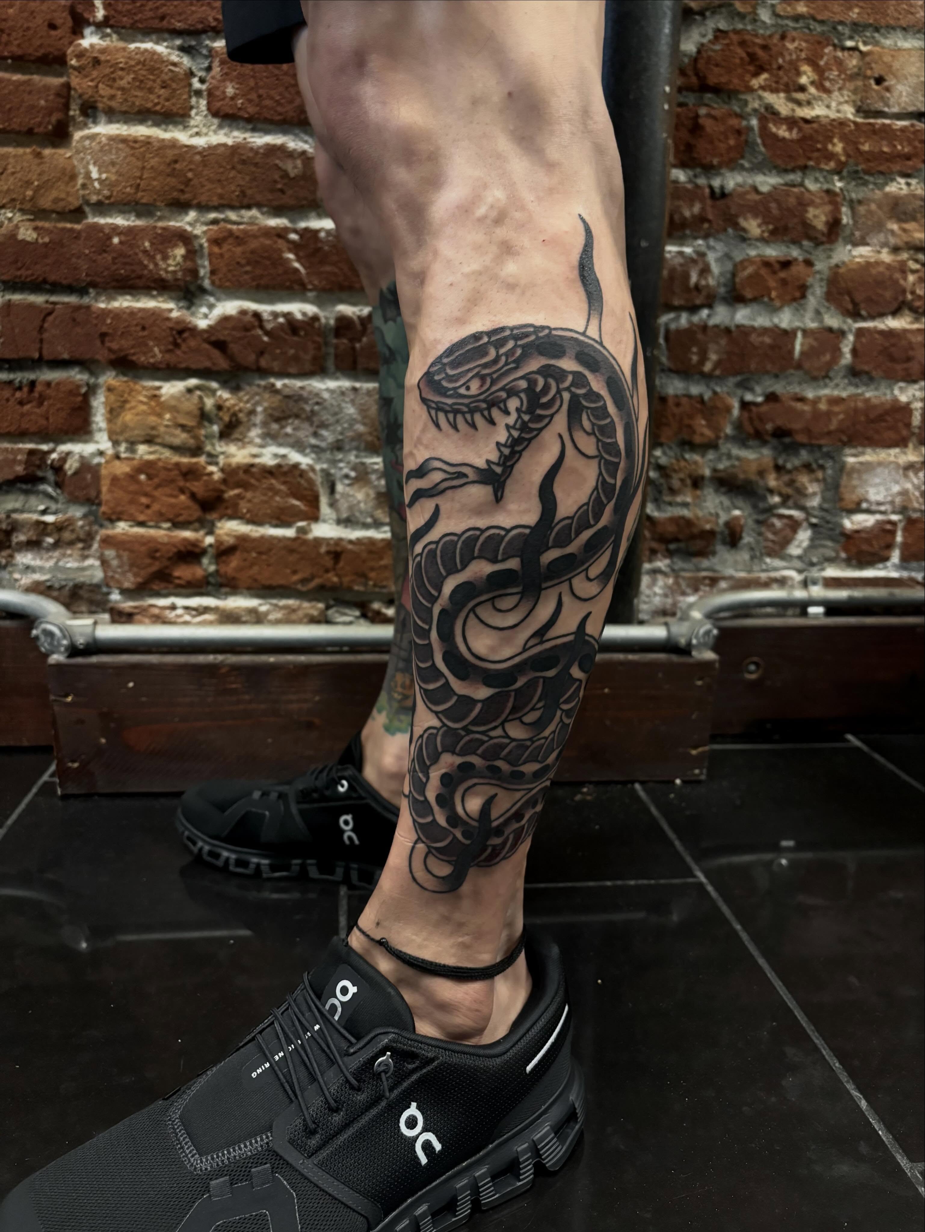 Snake black and grey tattoo on the calf by Alyssa L'Heureux🕴🏼, Los Angeles, California