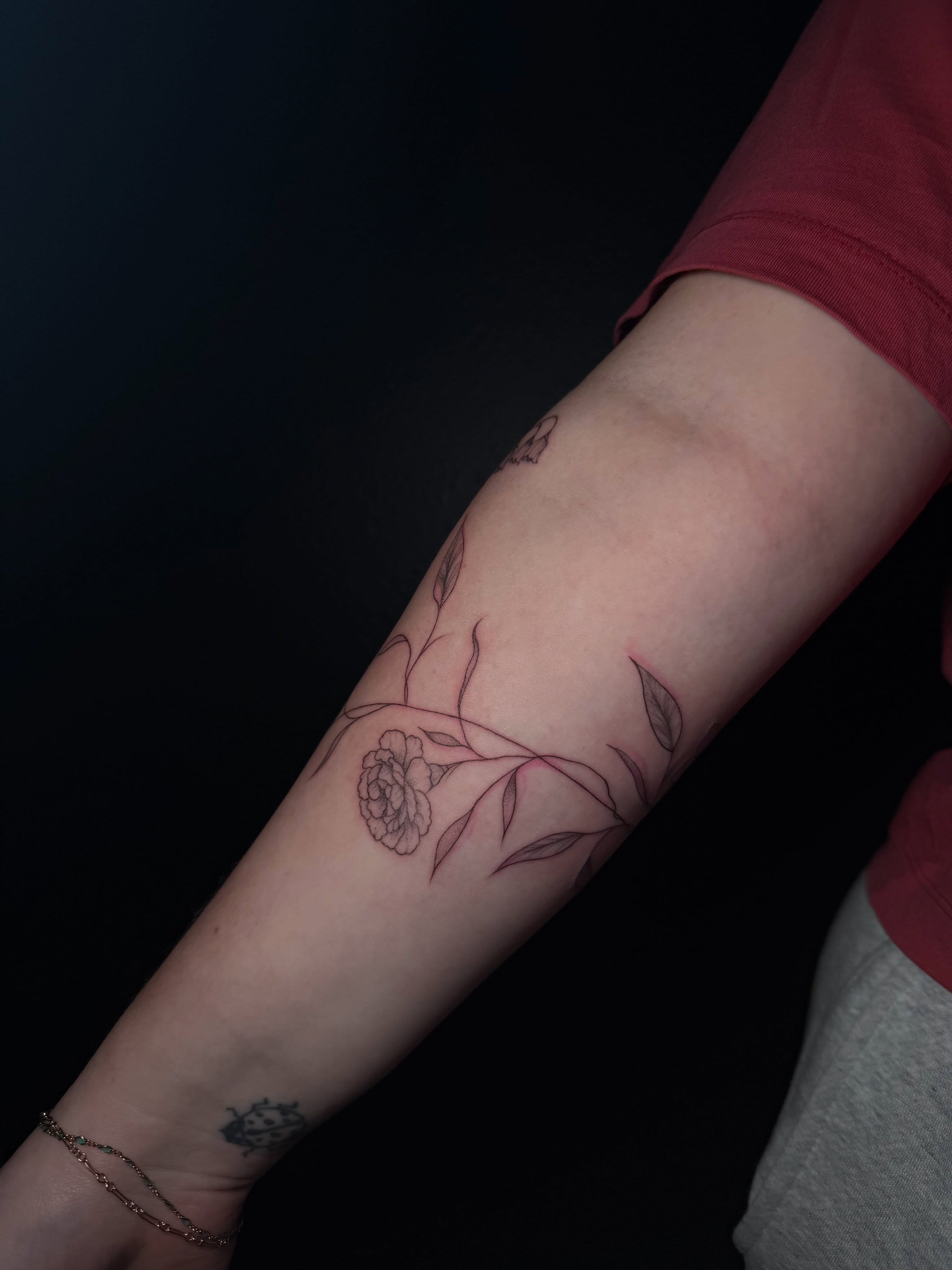 Peony and leaves fine line tattoo on the forearm by Ink Darling, Carlisle, Iowa