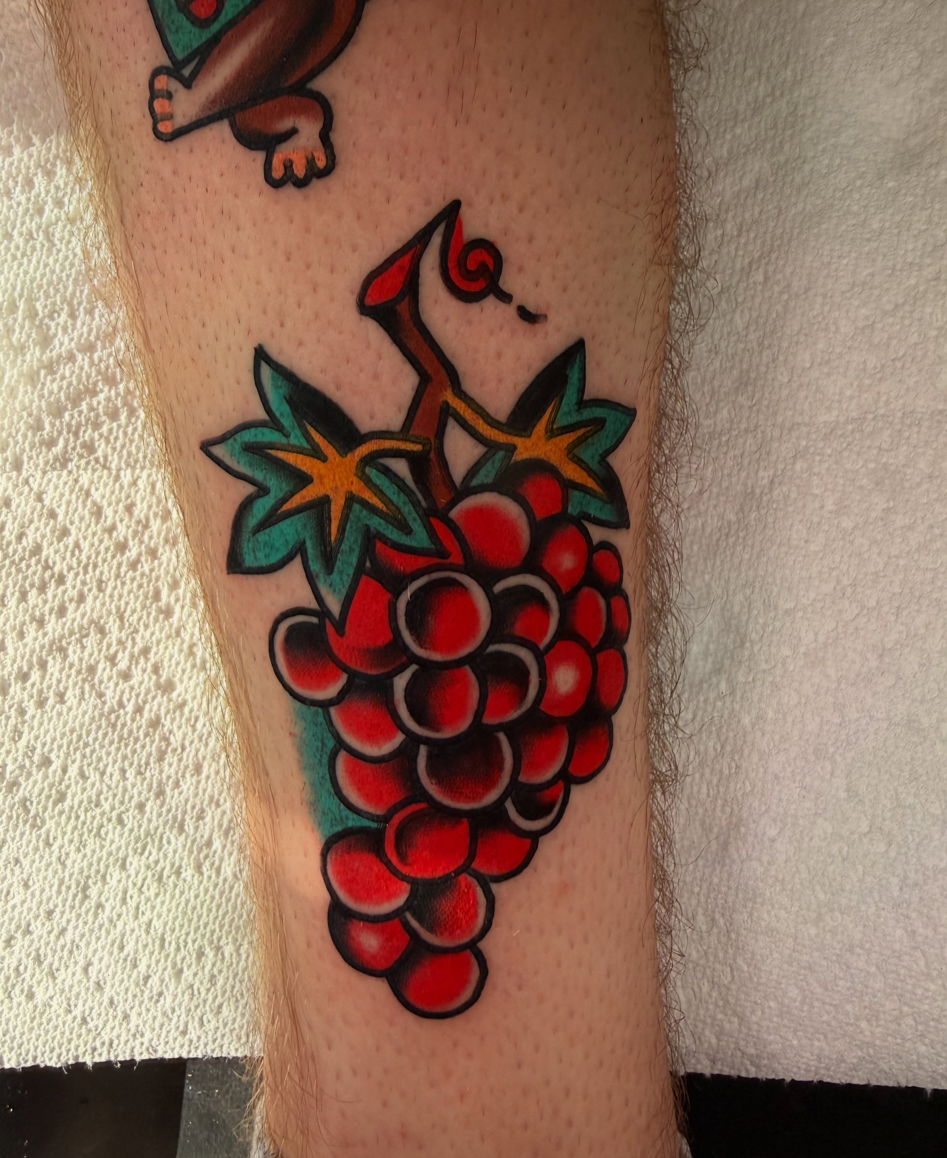Grapes American traditional tattoo on the forearm by {{Theo Glanton}}