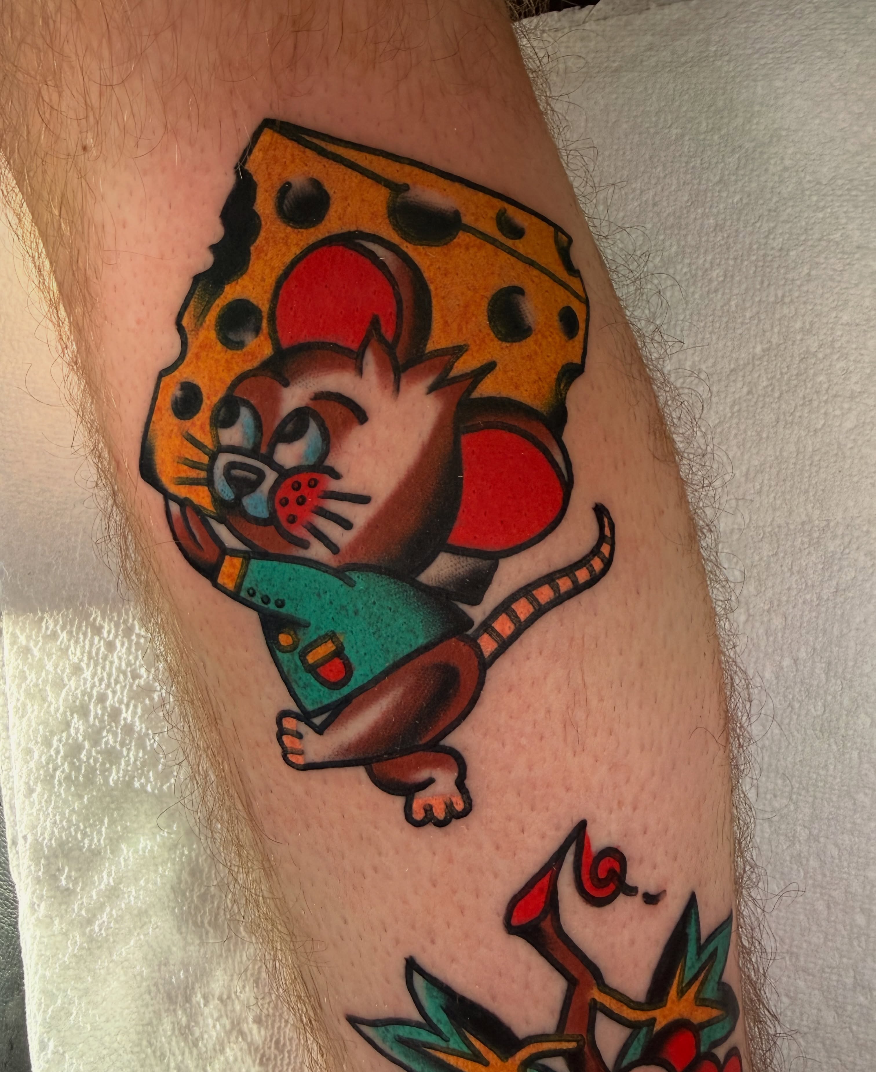 Mouse and cheese American traditional tattoo on the forearm by {{Theo Glanton}}
