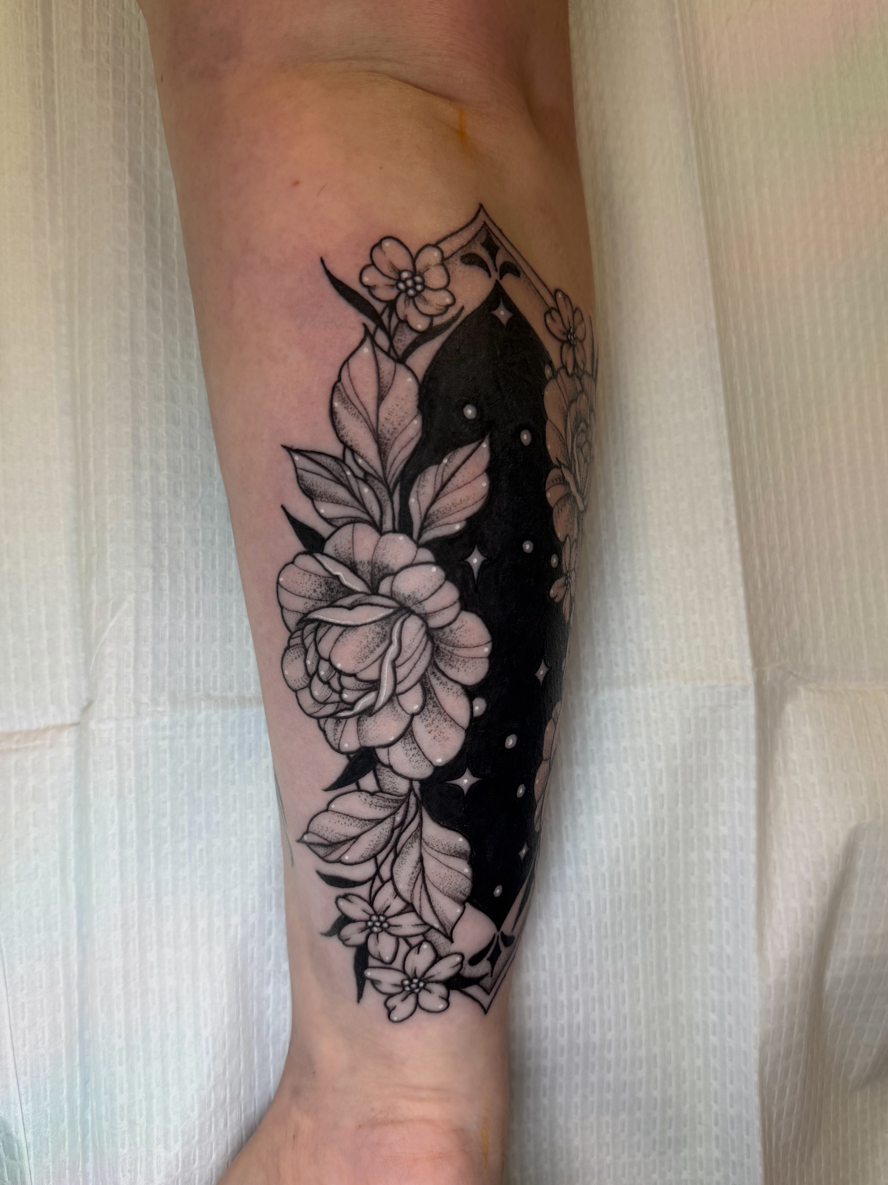 Flower and night sky dotwork tattoo on the forearm by McKenna