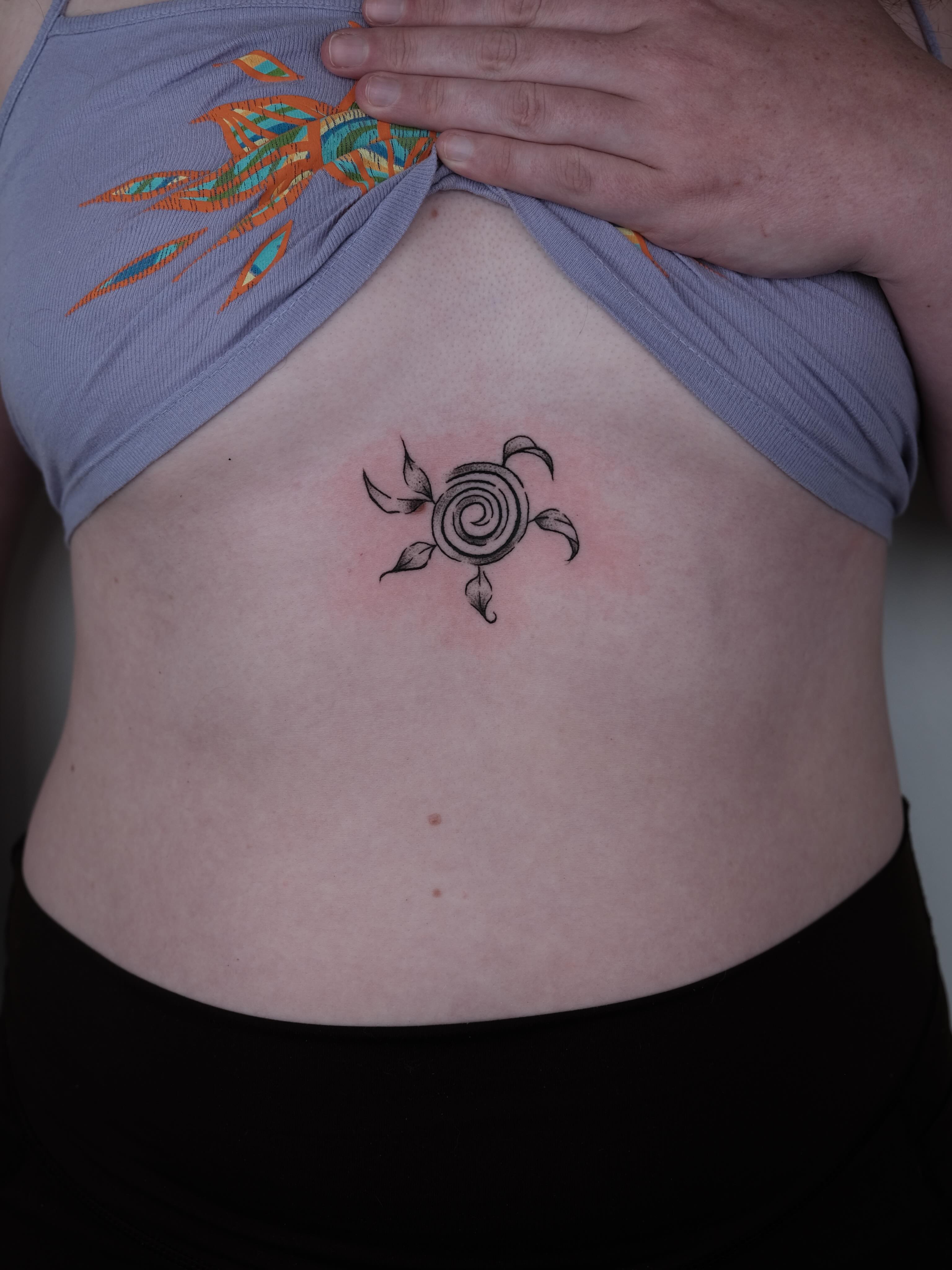 Spiral turtle black and grey tattoo on the torso by Elana Hites