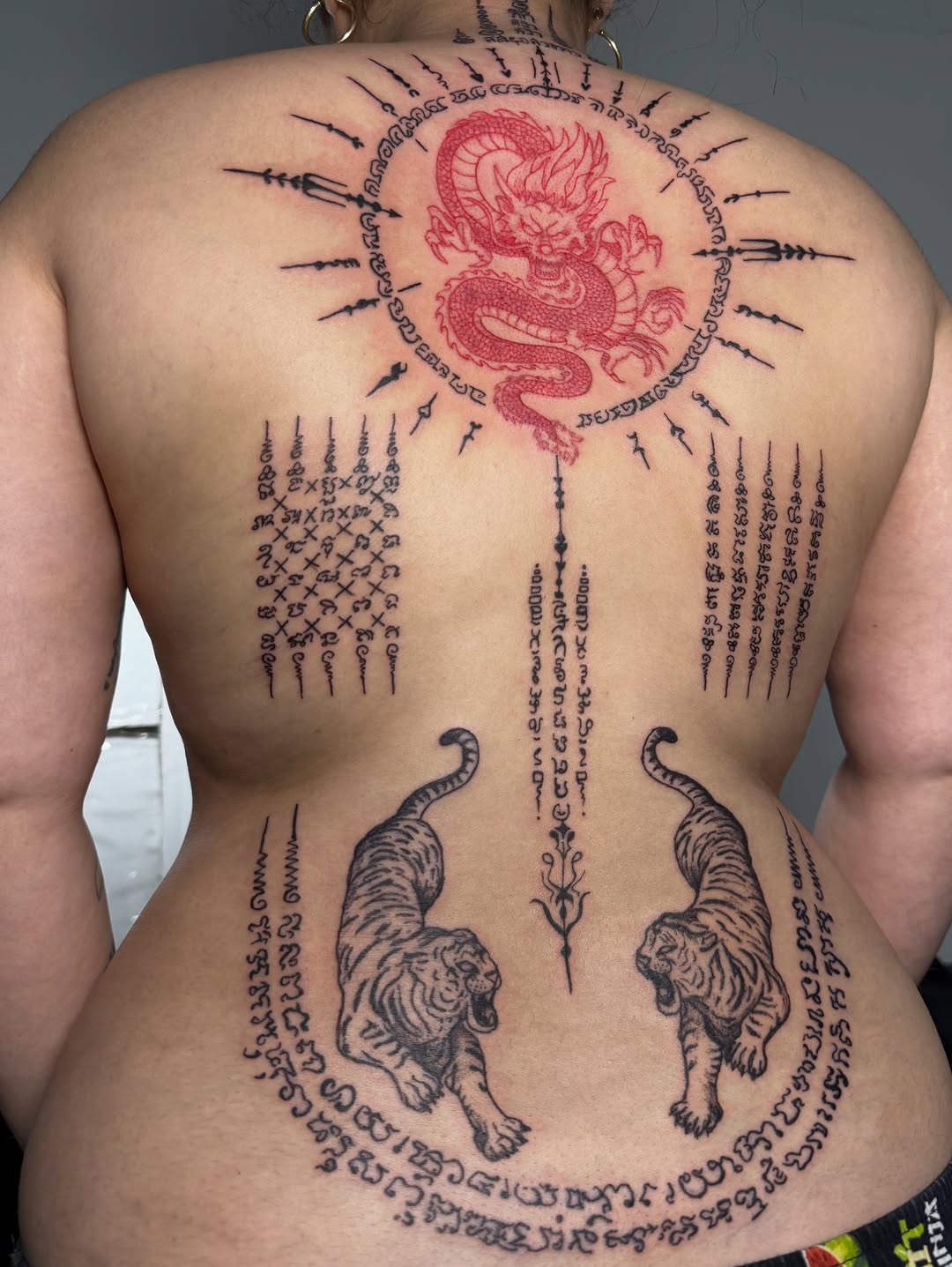 Dragon and tigers with script Japanese tattoo on the back by Victoria