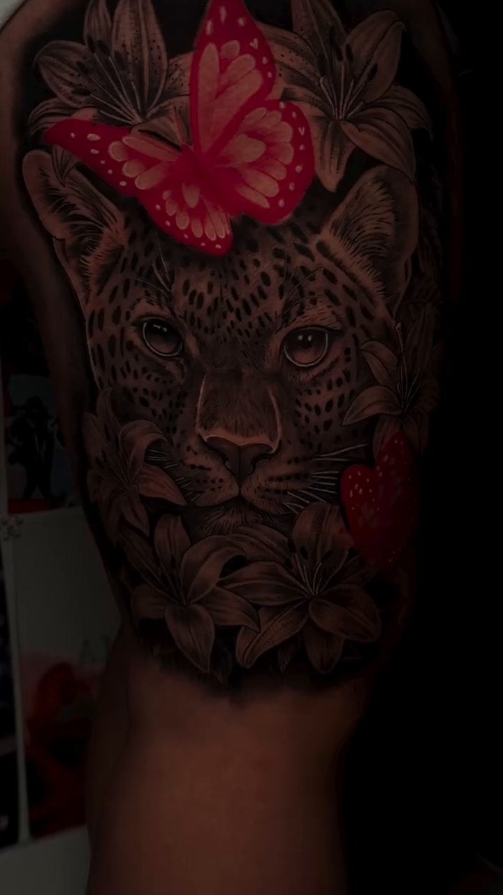 Leopard with butterfly and hearts realism tattoo by Thomas