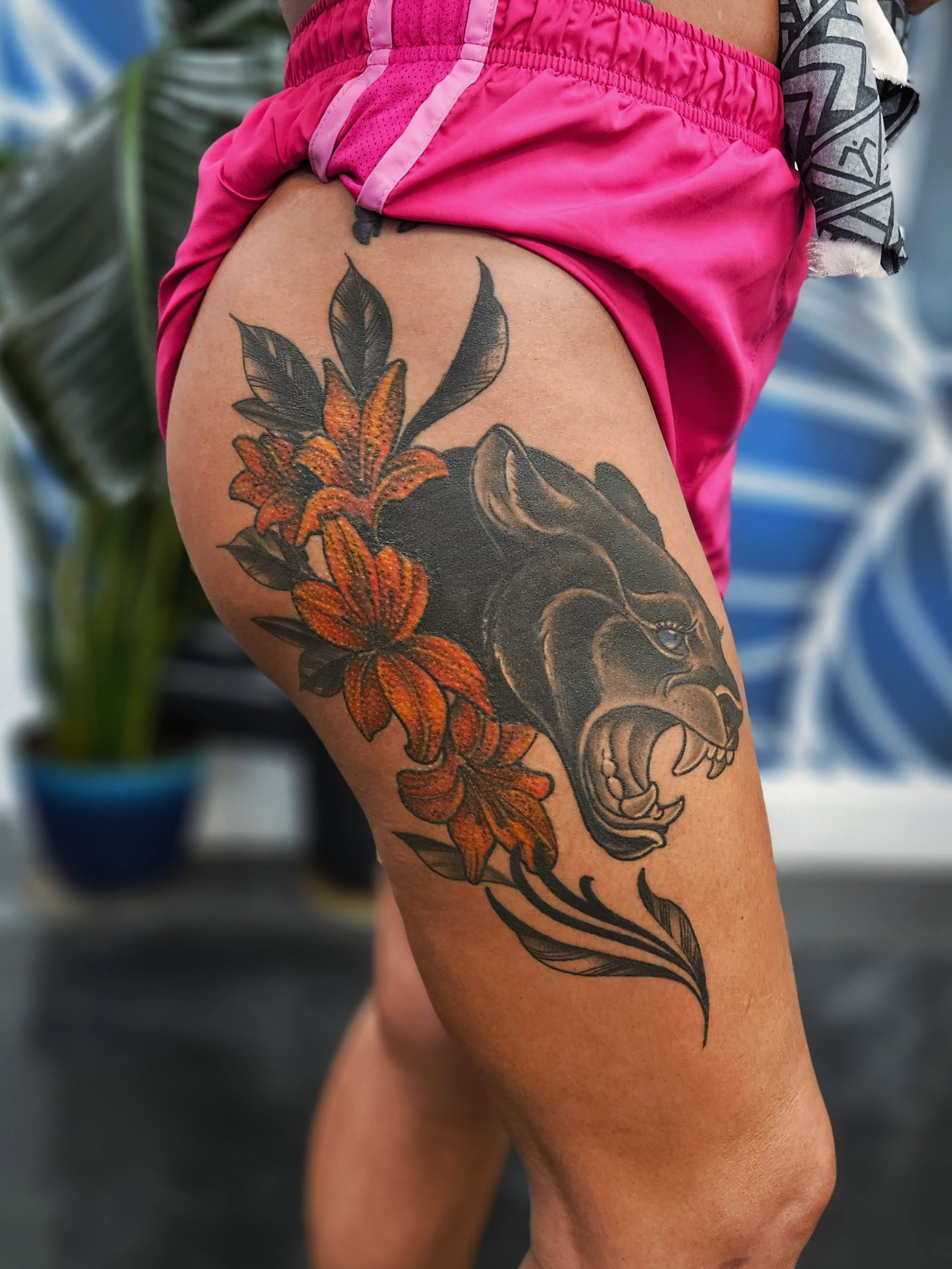 Panther and flowers realism tattoo on the thigh by Jo'el Acoba