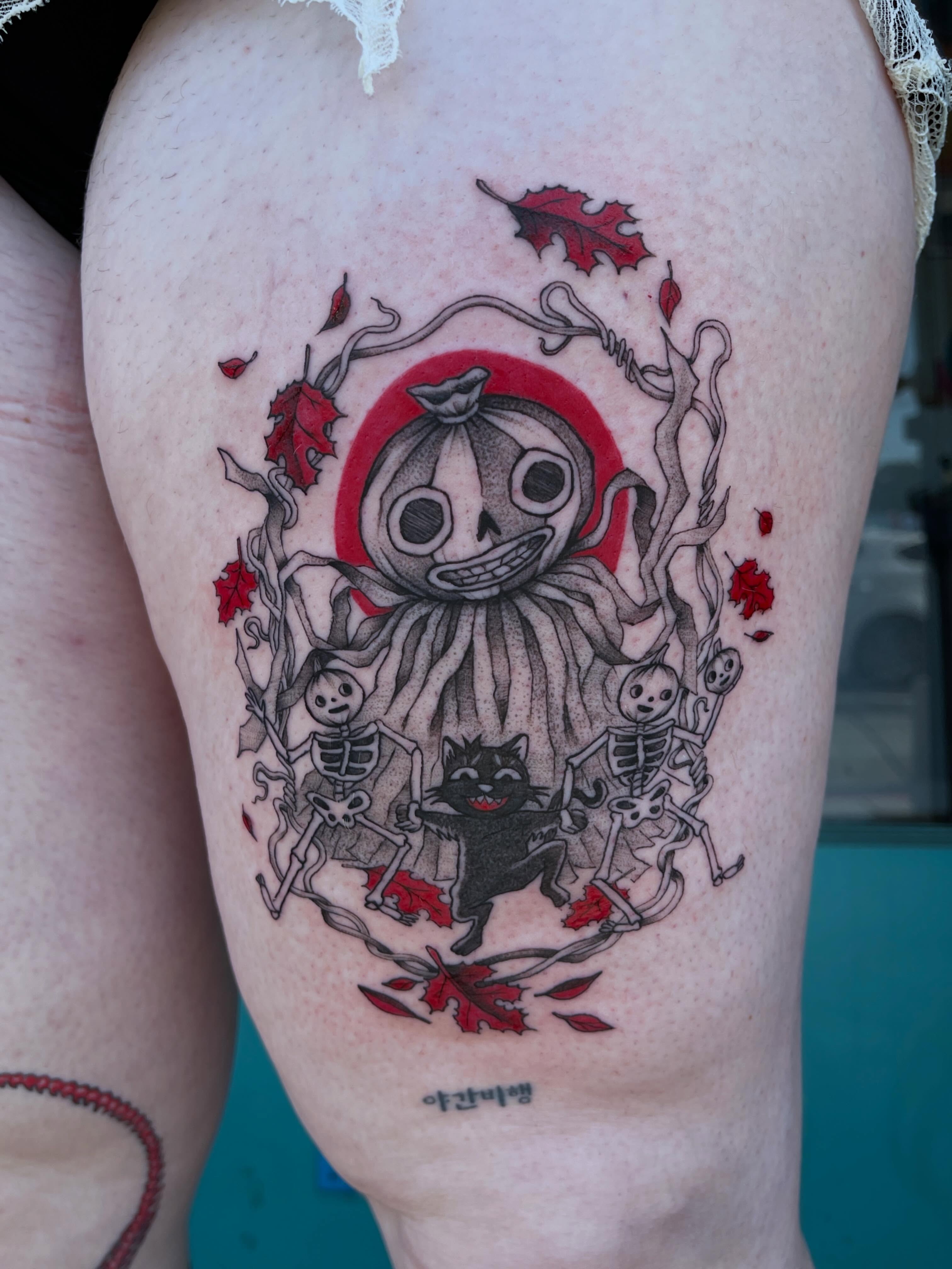 Pumpkin ghost with skeletons dark realism tattoo on the thigh by cindy ha soul son