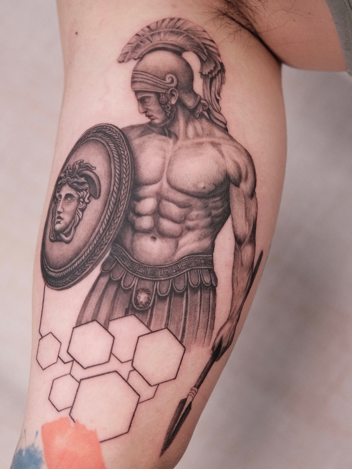 Muscular warrior with Medusa shield realism tattoo on the forearm by Houston Tattoo Artist GoldenK