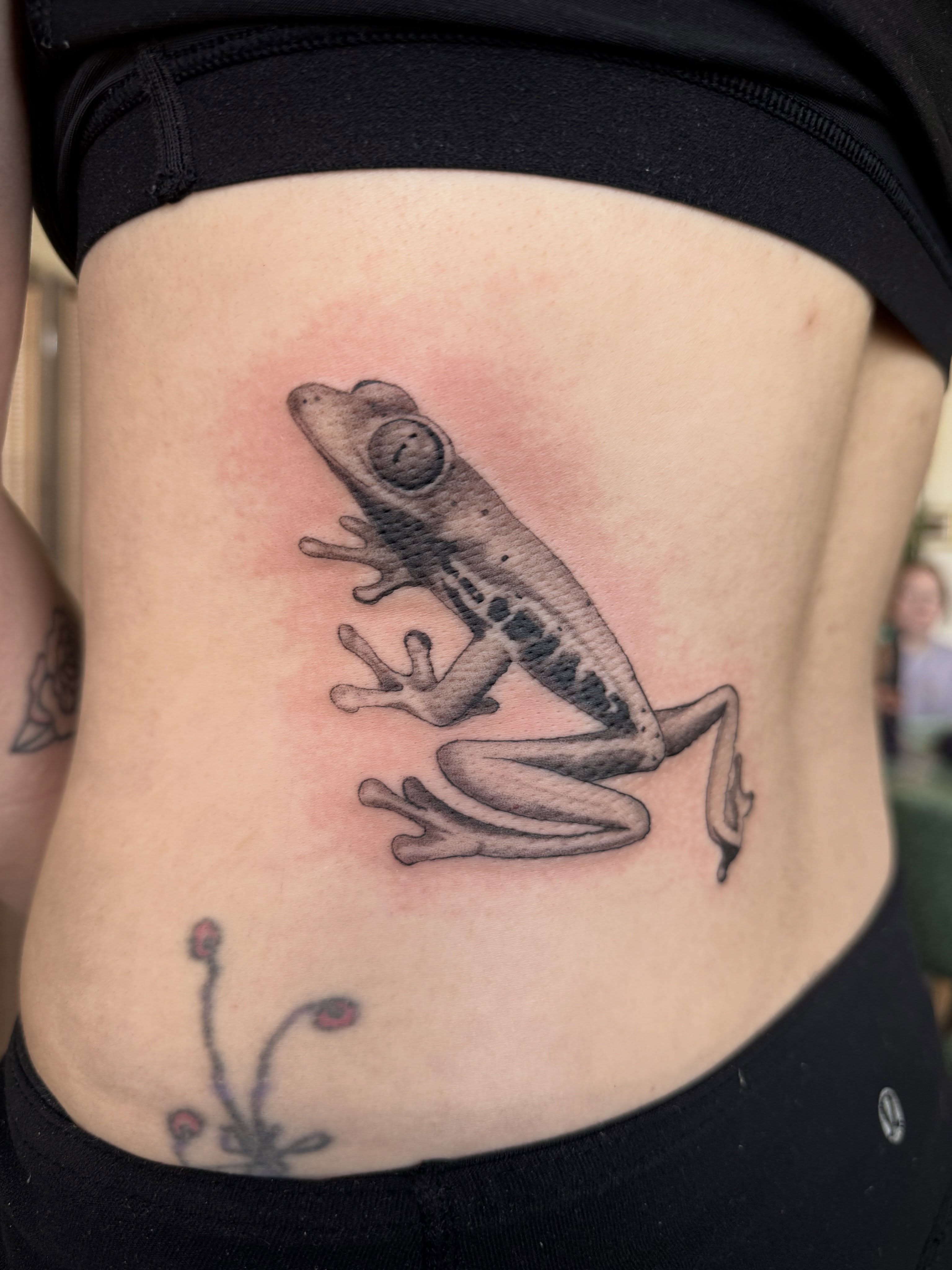 Frog realism tattoo on the ribs by Leah - Tattoo Artist