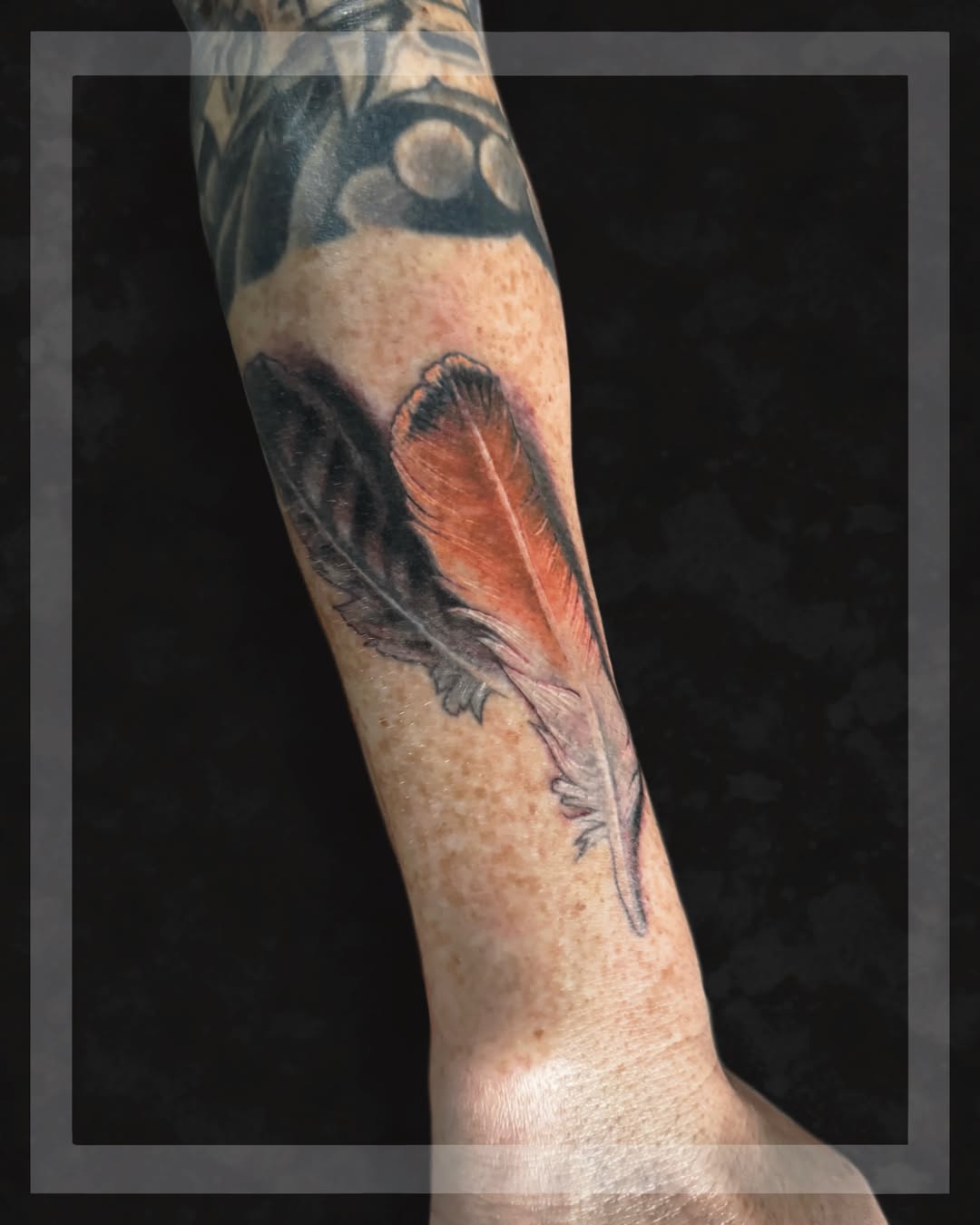 Feather realism tattoo on the forearm by Belfry Tattoo