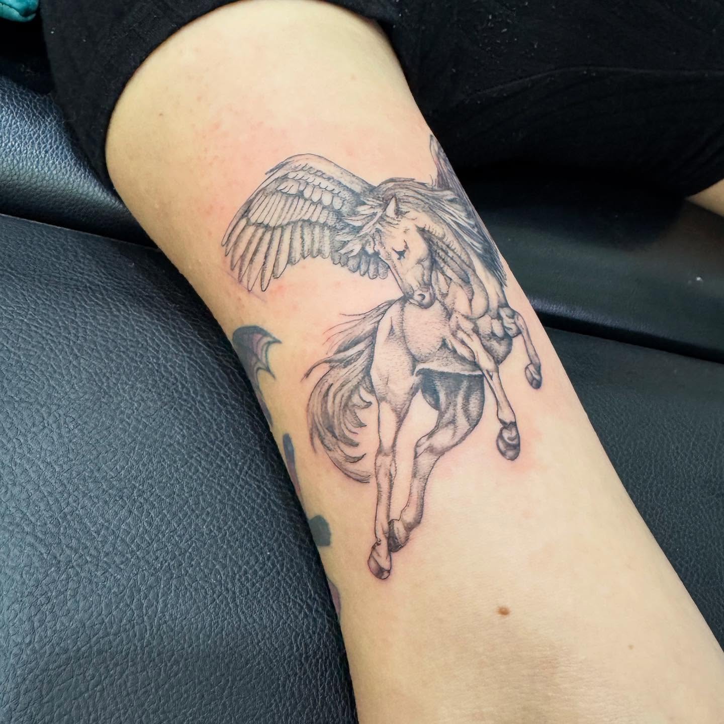 Winged horse black and grey tattoo on the forearm by C.J. Pennington