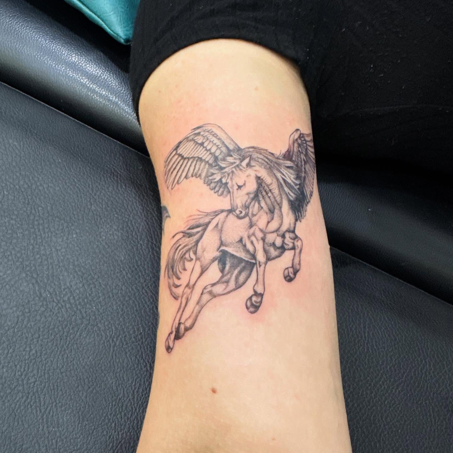 Pegasus black and grey tattoo on the forearm by C.J. Pennington