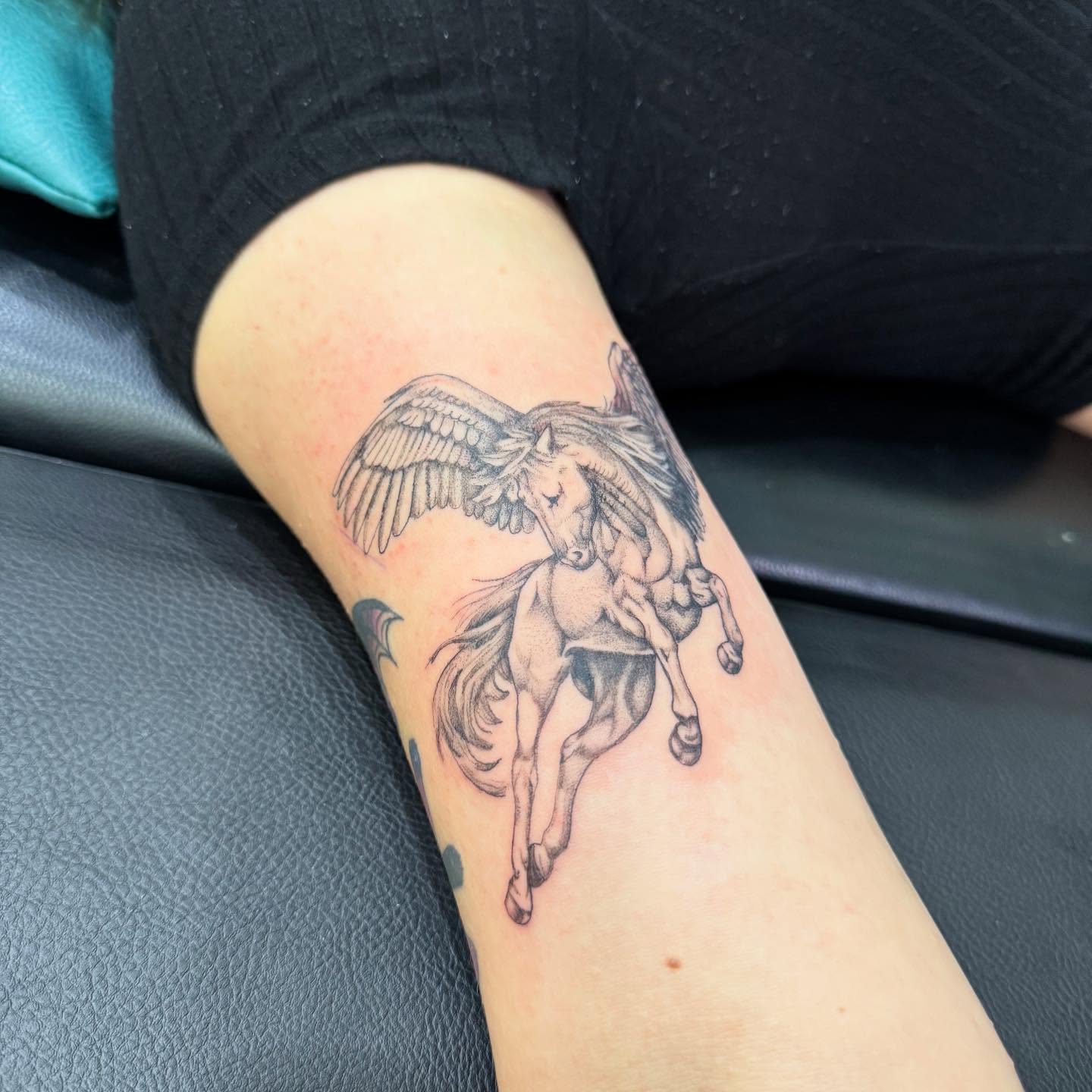 Pegasus black and grey tattoo on the forearm by C.J. Pennington