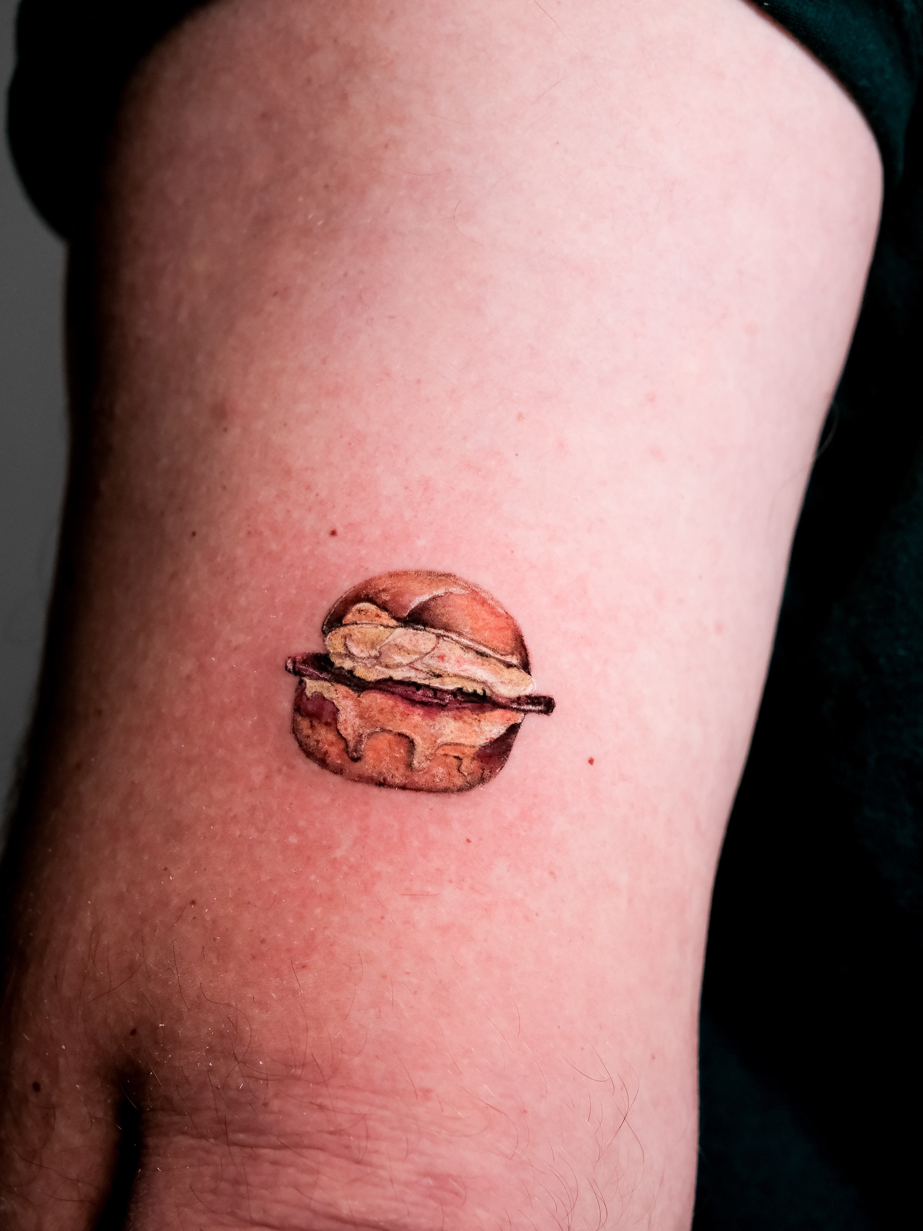 Hamburger realism tattoo on the forearm by NAS