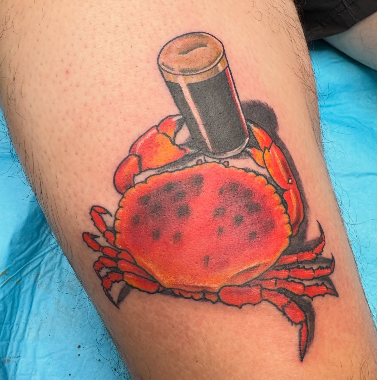 Crab with bottle realism tattoo on the thigh by Joel Smith, Manhattan, Kansas