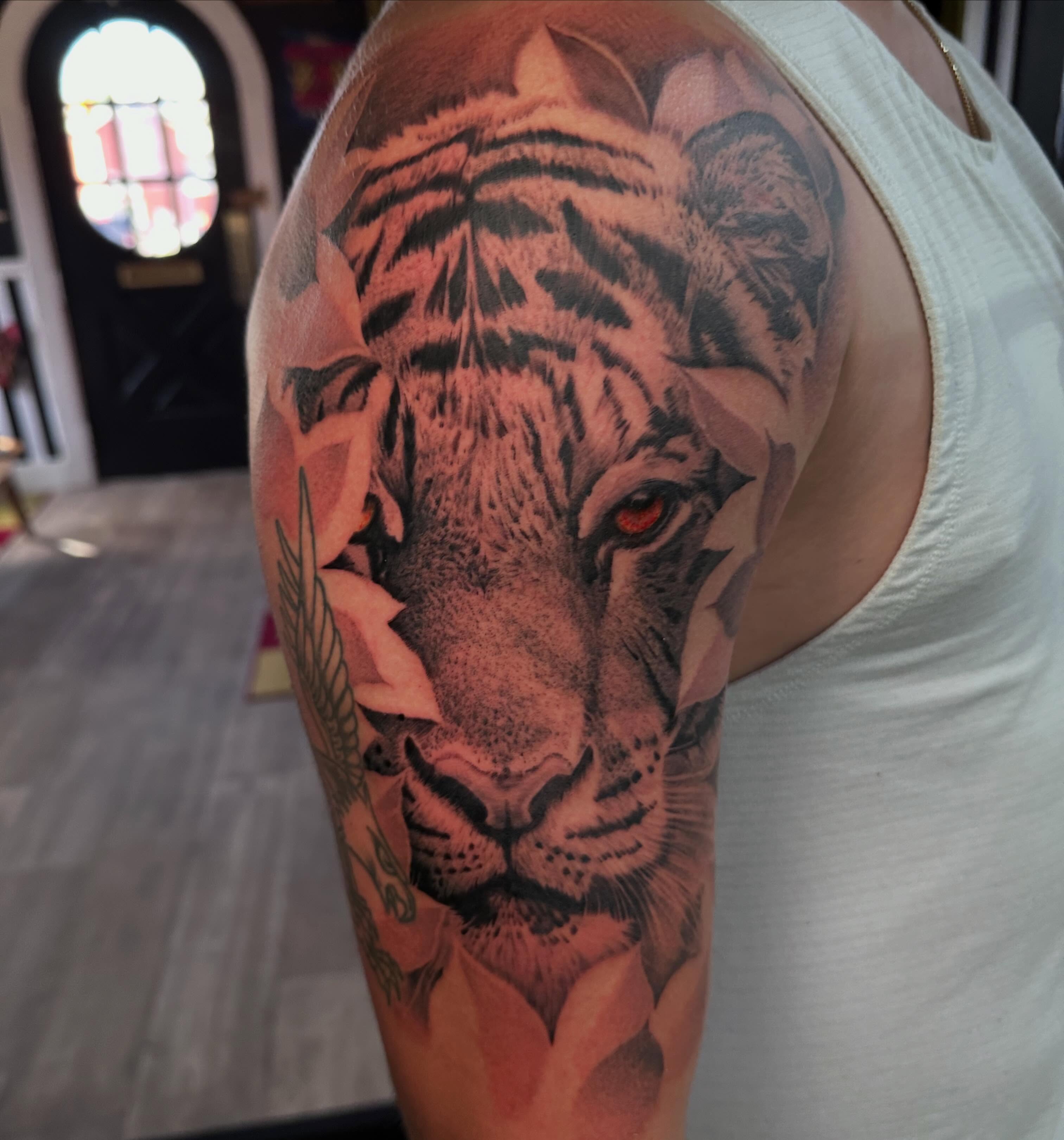 Tiger realism tattoo on the upper arm by Dustin Clark, Dayton, Ohio