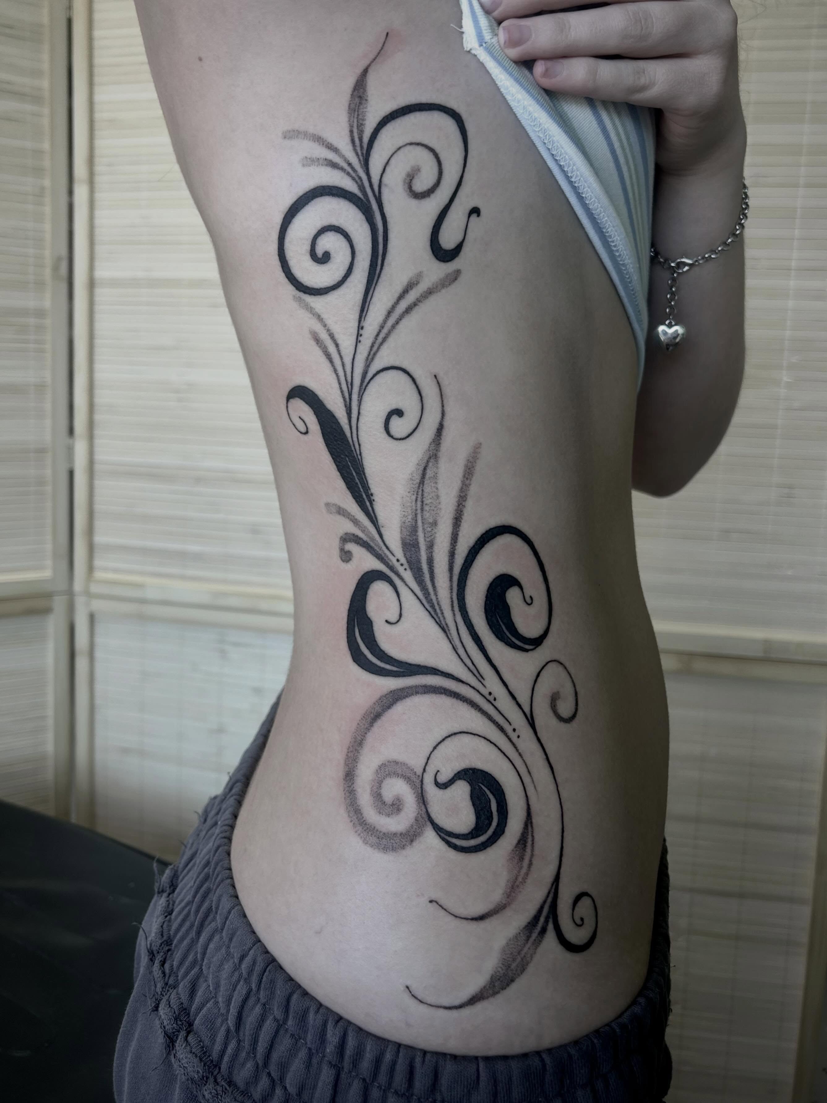 Swirls black and grey tattoo on the thigh by Bria🩸
