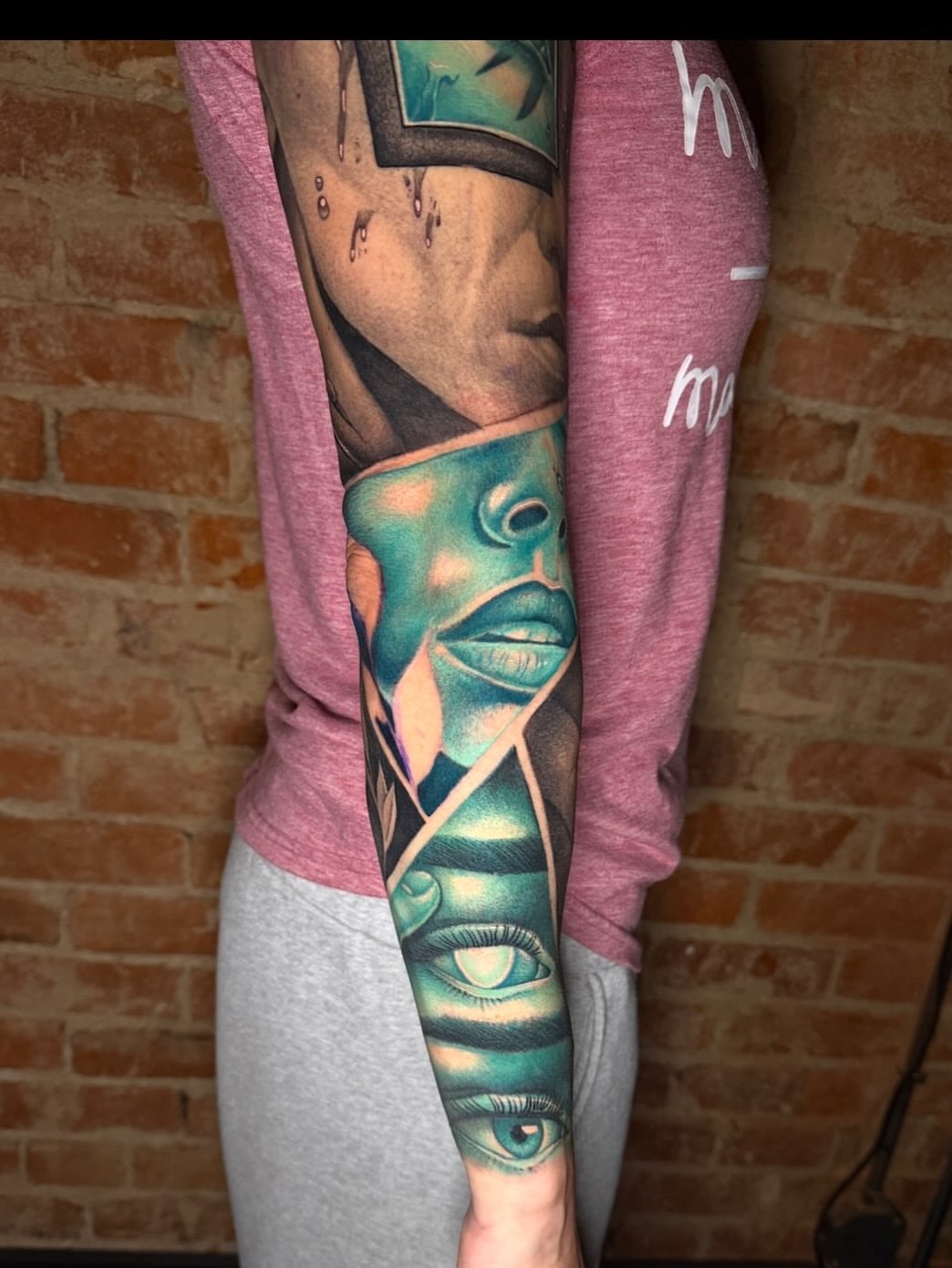 Abstract face geometric tattoo on the forearm by Taylor Steckman