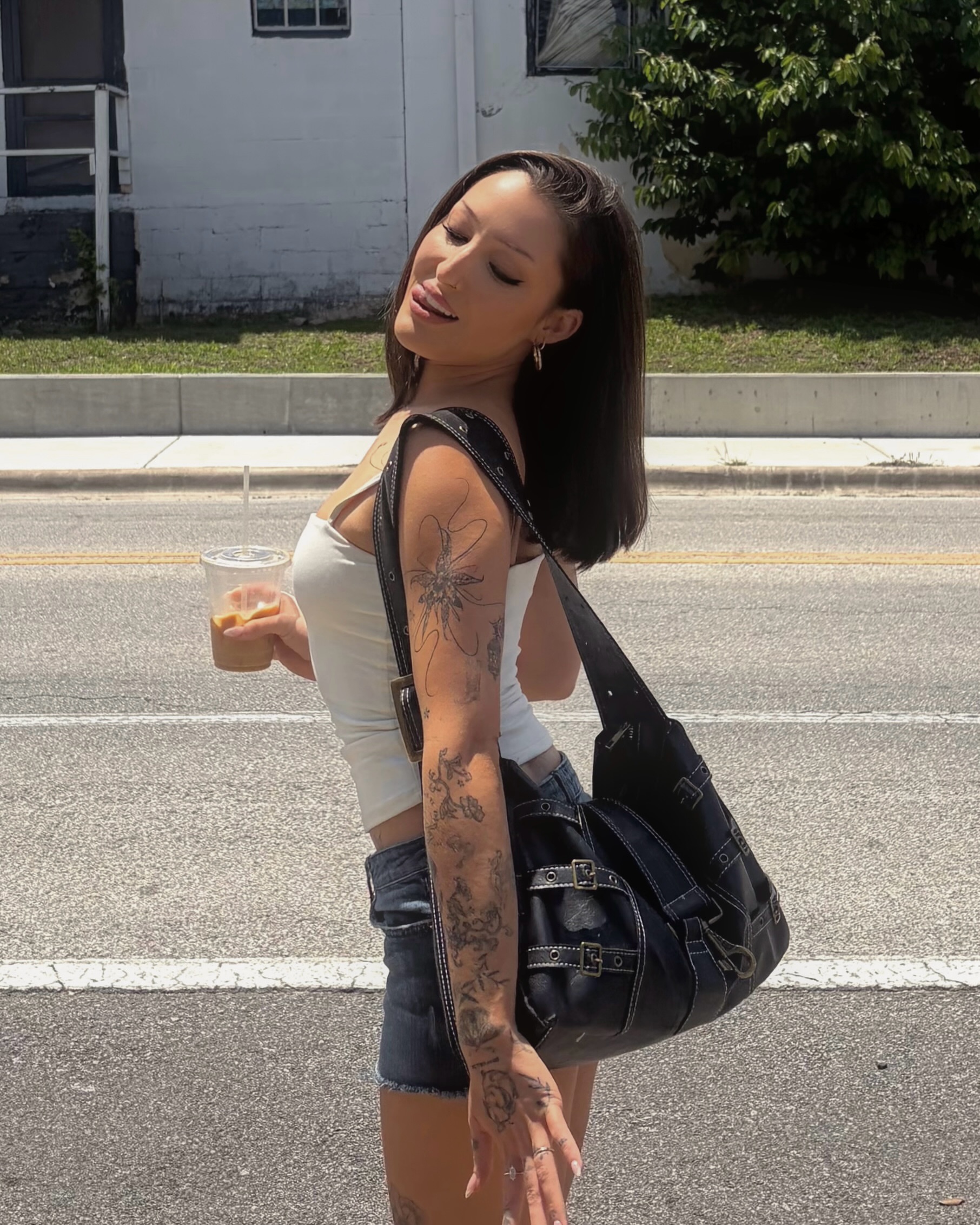 Floral design black and grey tattoo on the upper arm by Kylah Amin Tattoo