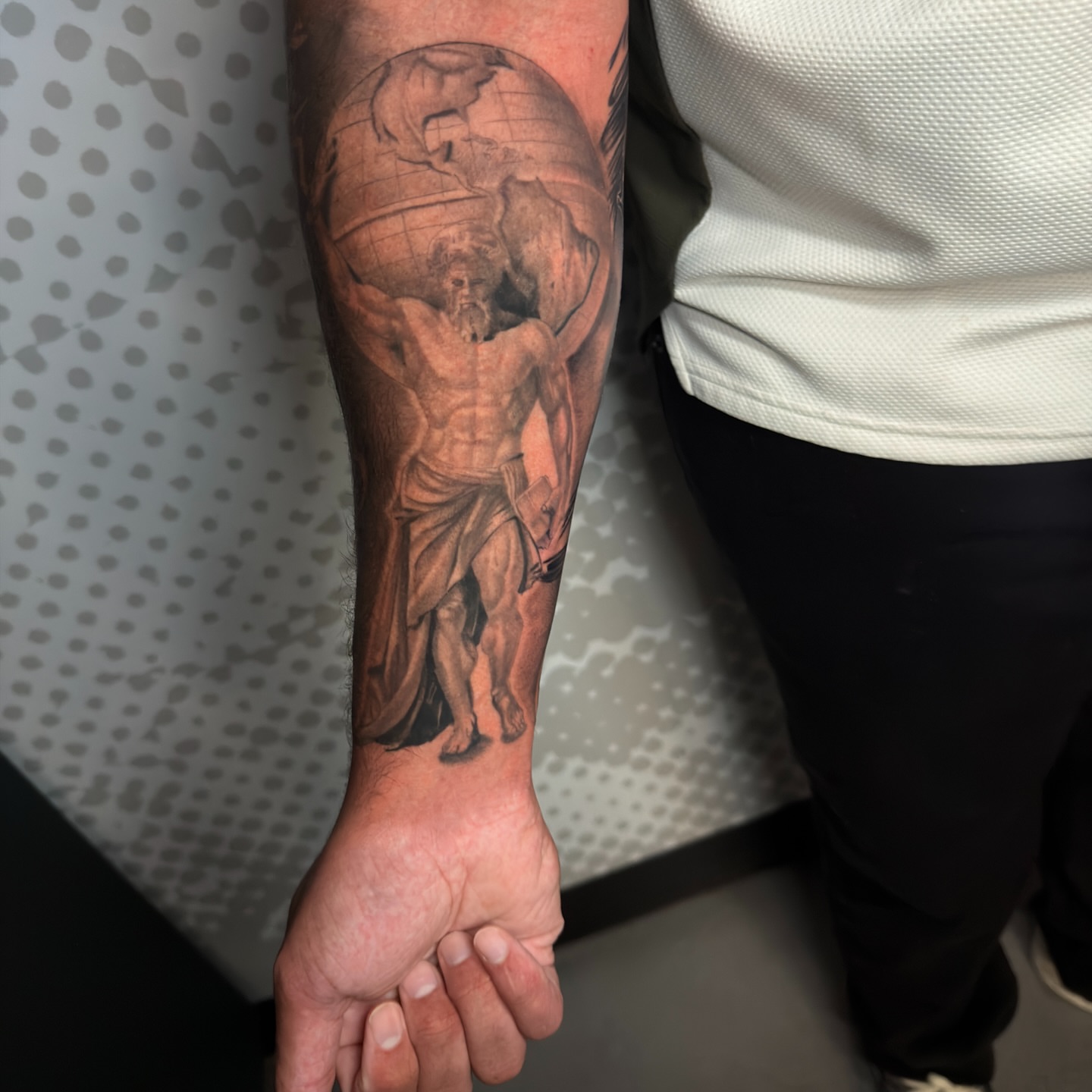 Statue of atlas realism tattoo on the forearm by Charlotte Tattoo Artist