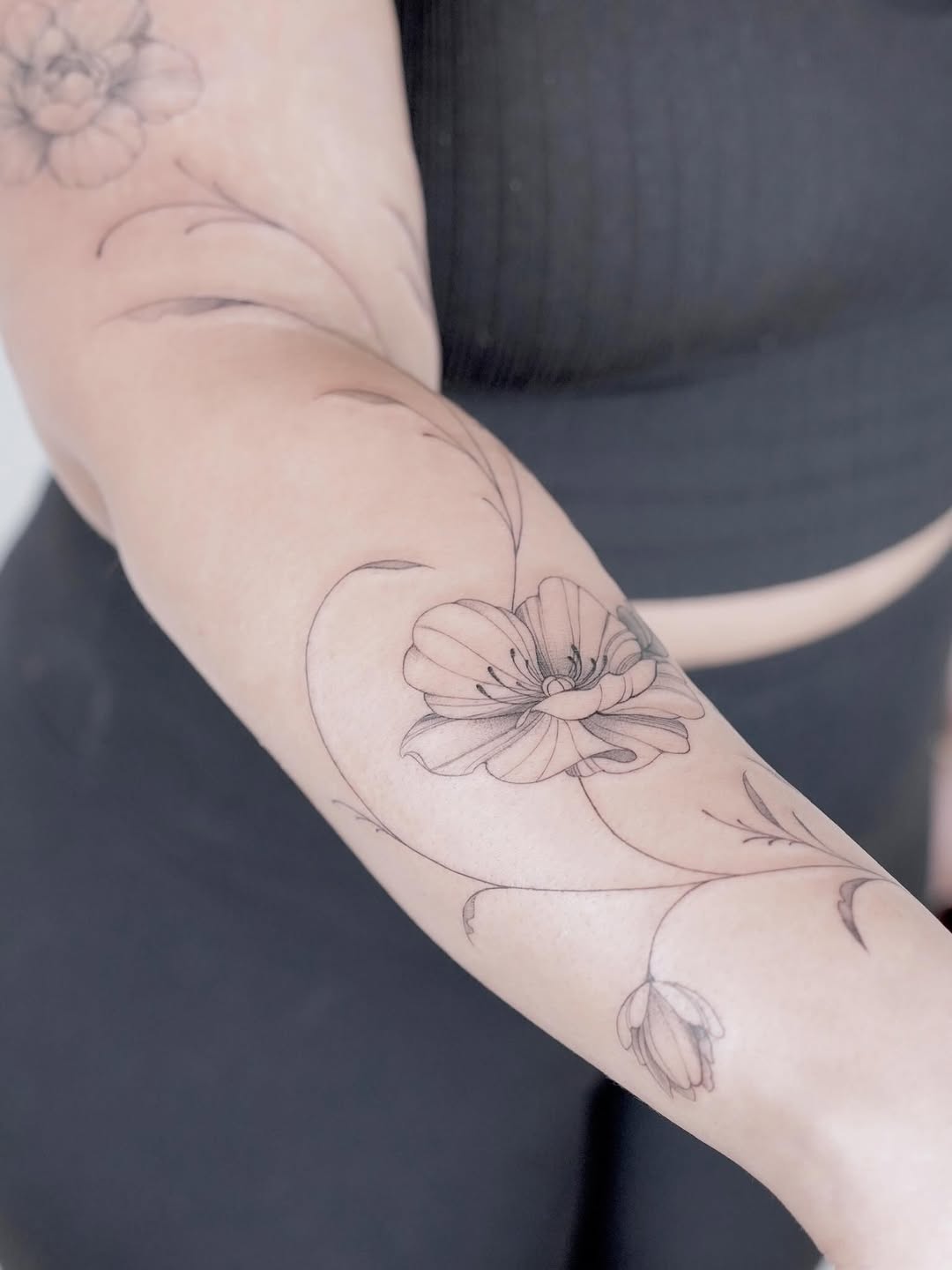 Flower and vine fine line tattoo on the forearm by Julia