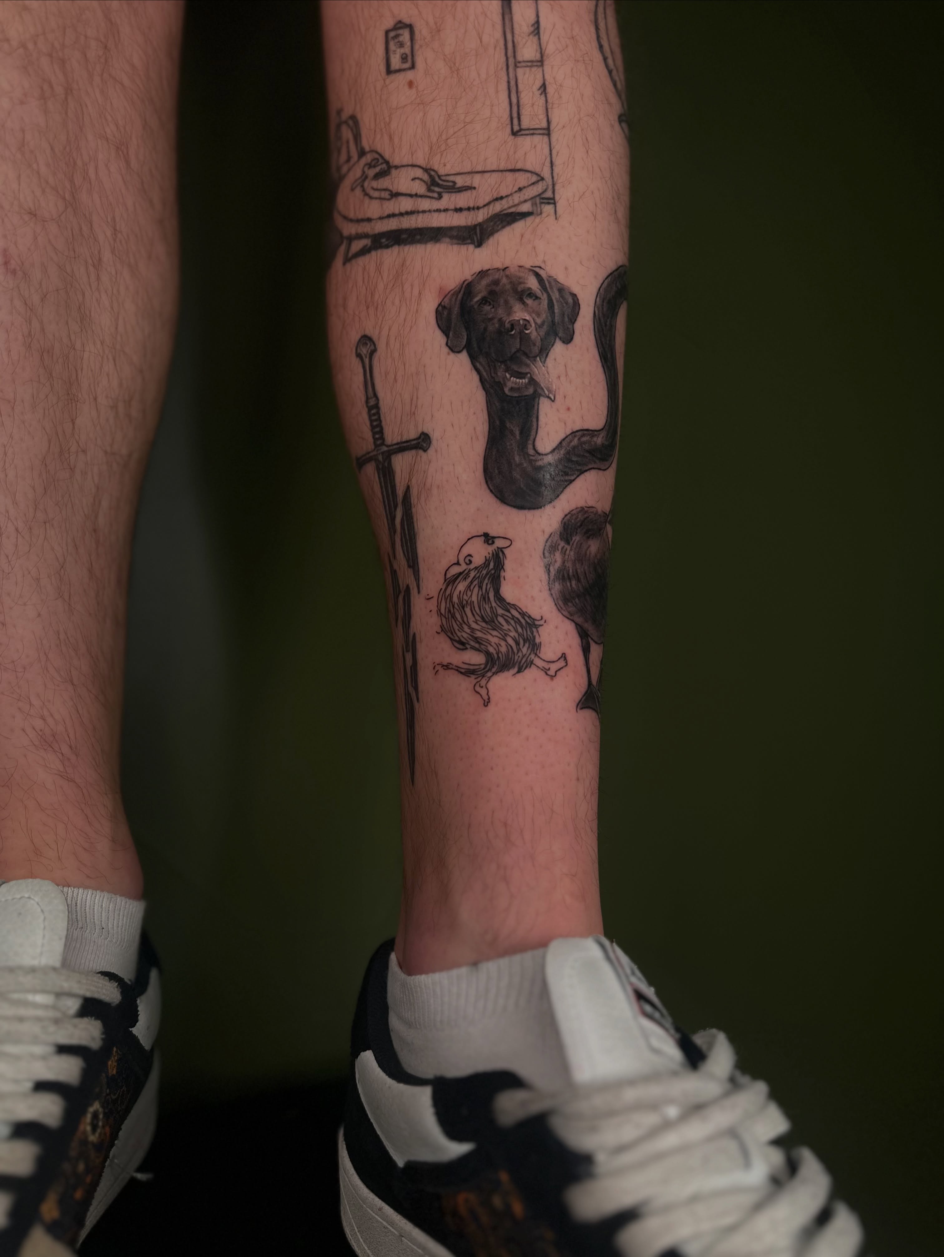 Dog and snake black and grey tattoo on the forearm by Nikolas Tapio Aatos Mäkelä